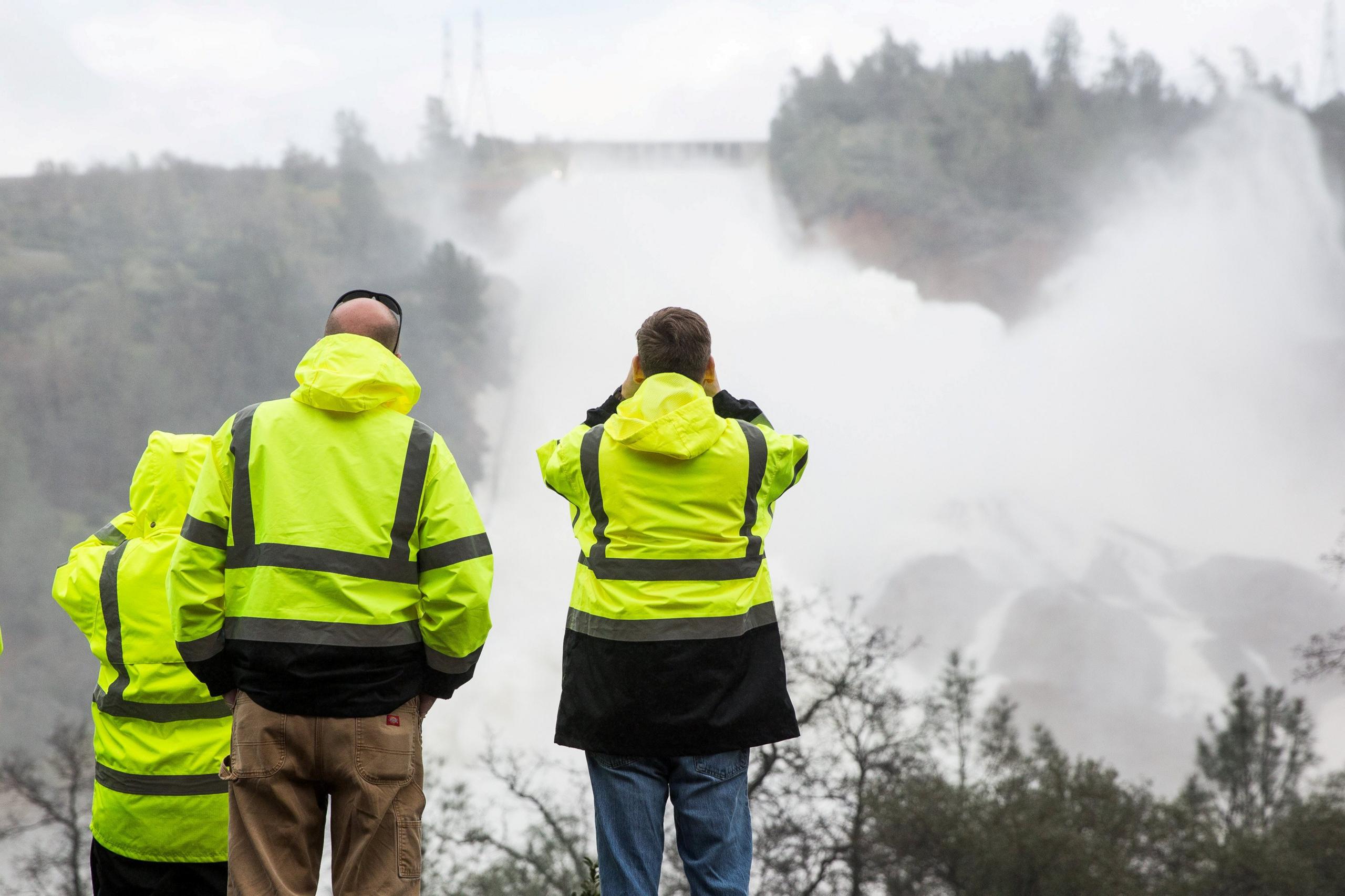 California Department of Water Resources staff monitoring the water flowing through the damaged spillway on Friday 10 February