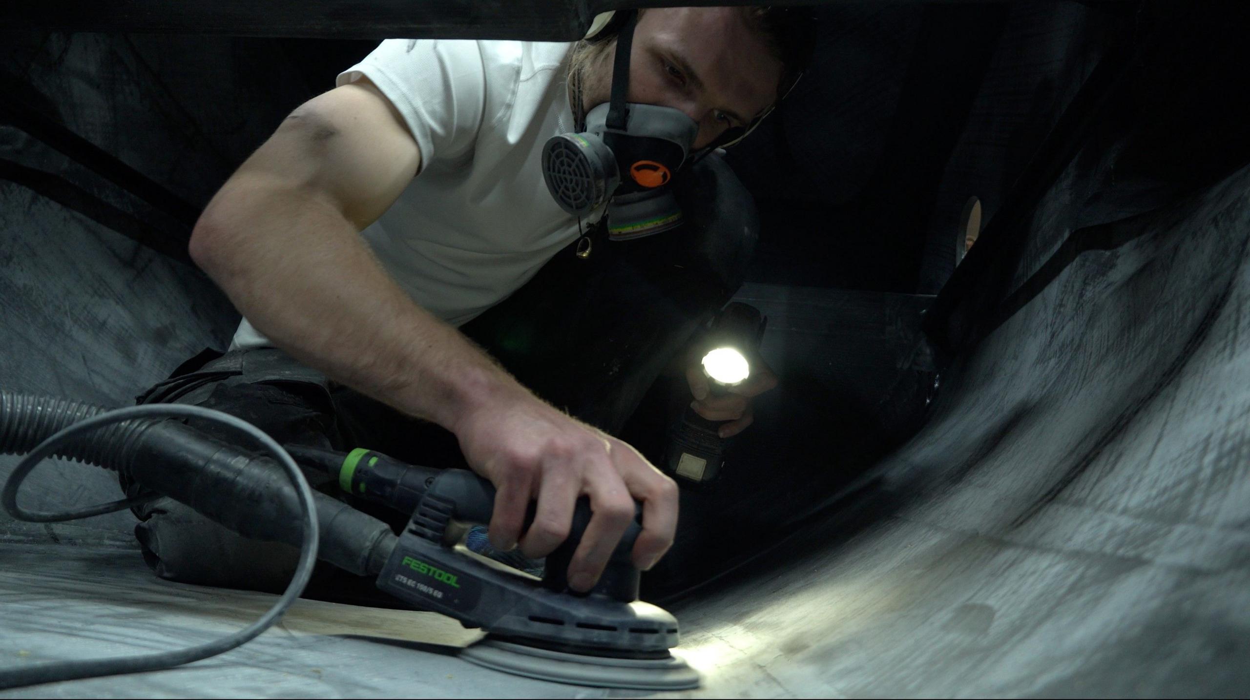 Lachlan MacLean sanding the deck