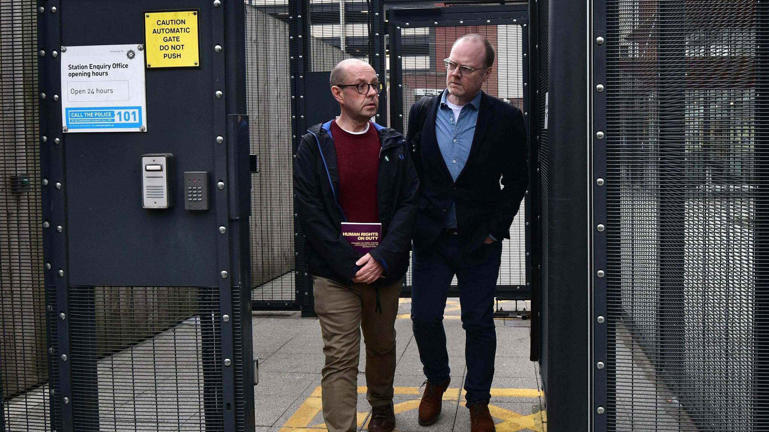 Journalists Barry McCaffrey and Trevor Birney leave Musgrave PSNI station in Belfast. 