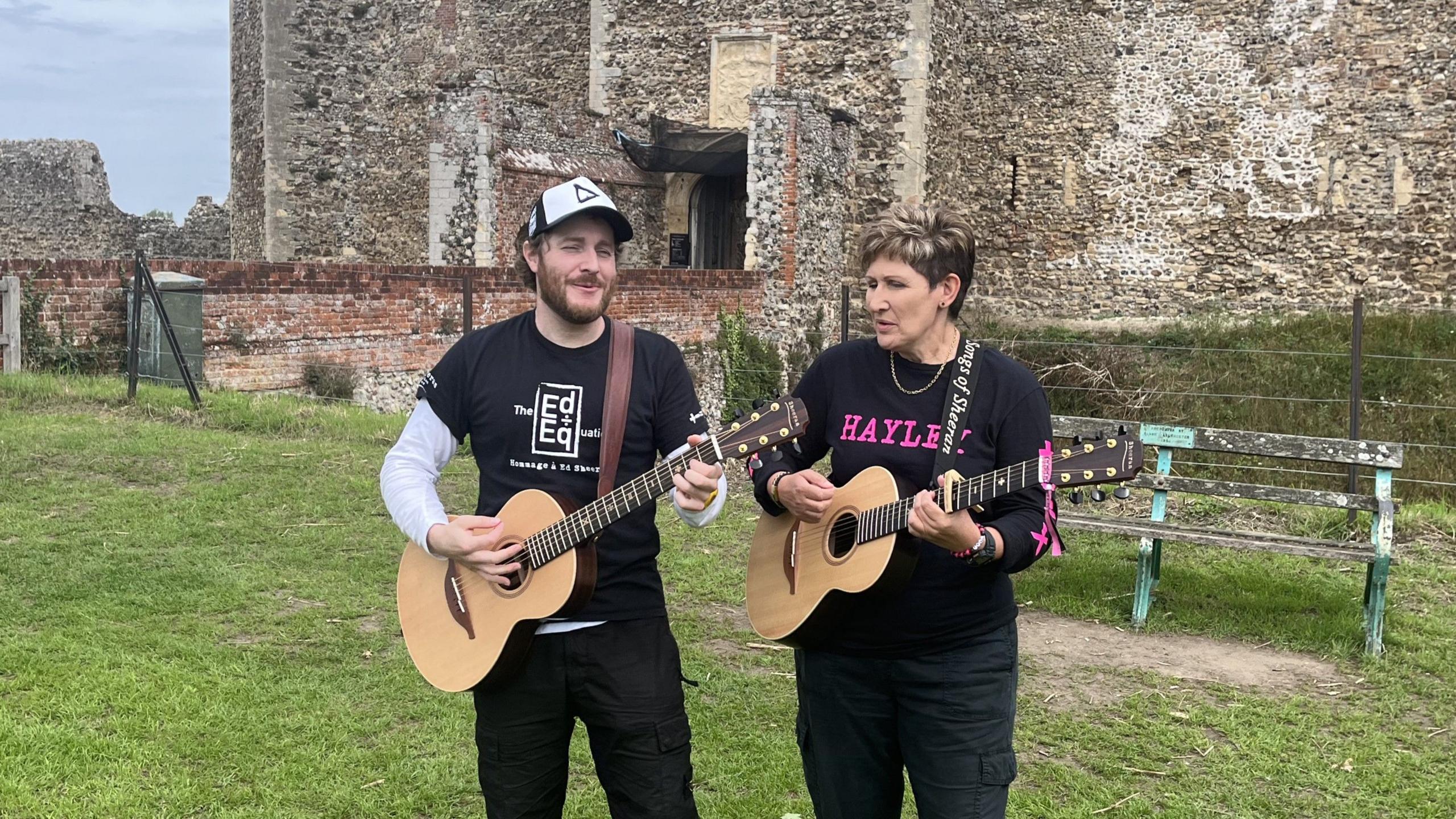 Benoit Plamondon and Hayley Judge play their respective guitars together and sing outside Framlingham Castle.