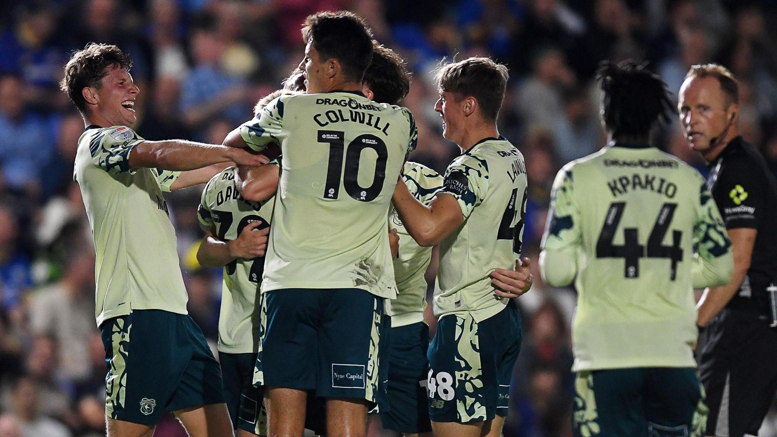 Cardiff players celebrate their late winner at Wimbledon