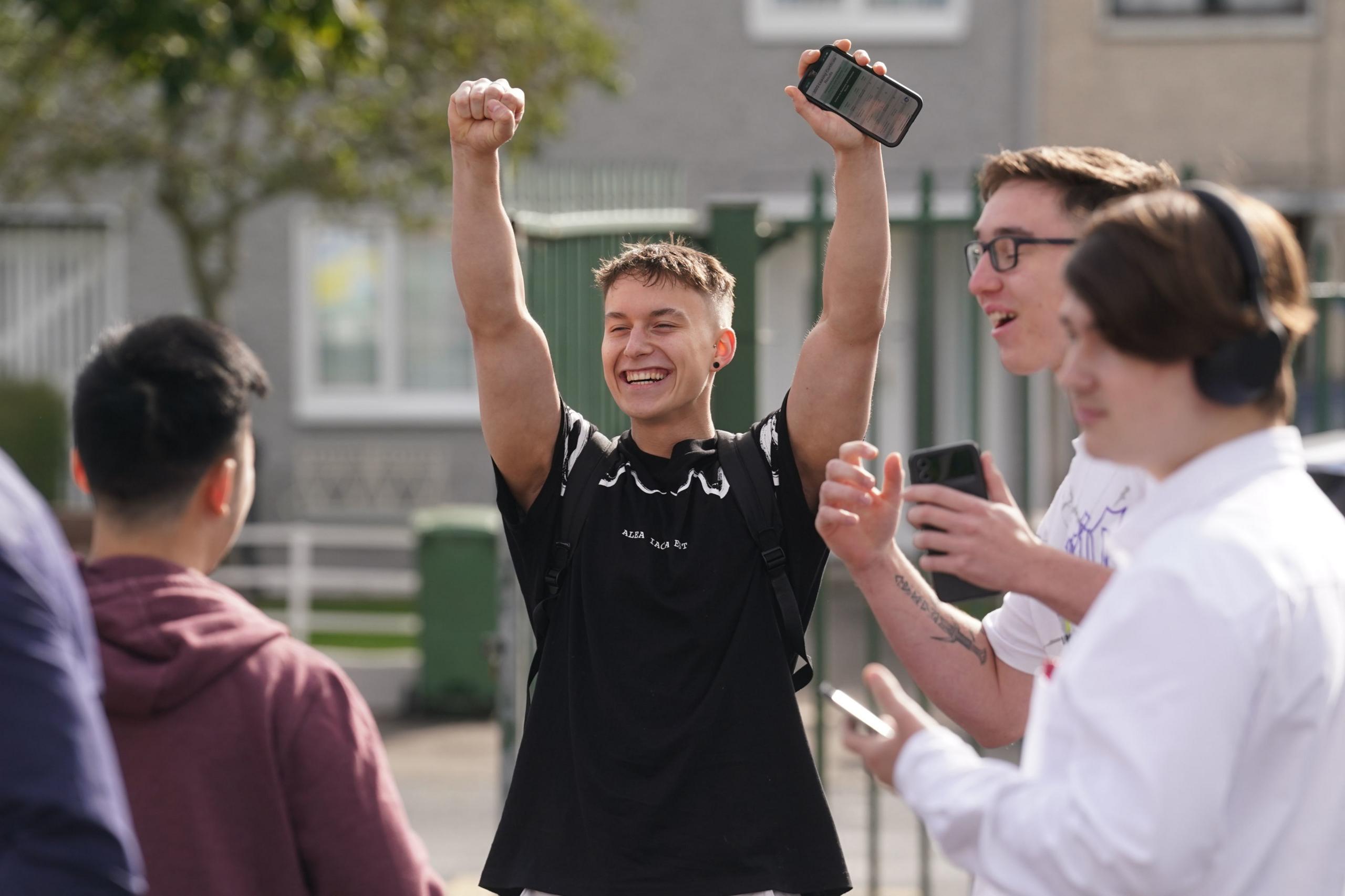 Elanas Zemaitis (second right) a pupil at Donahies Community School, Dublin, celebrates after receiving his Leaving Certificate results