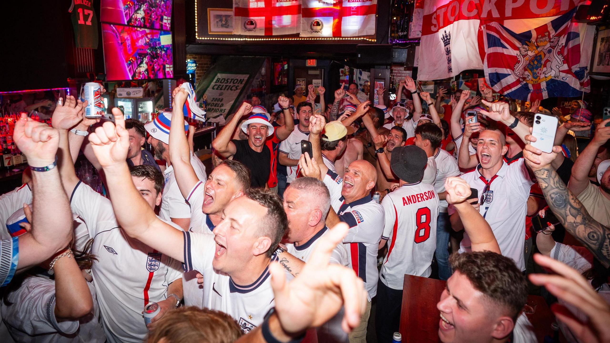 England fans in celebratory mood in a packed bar in Boston ahead of Tuesday's game against Ghana