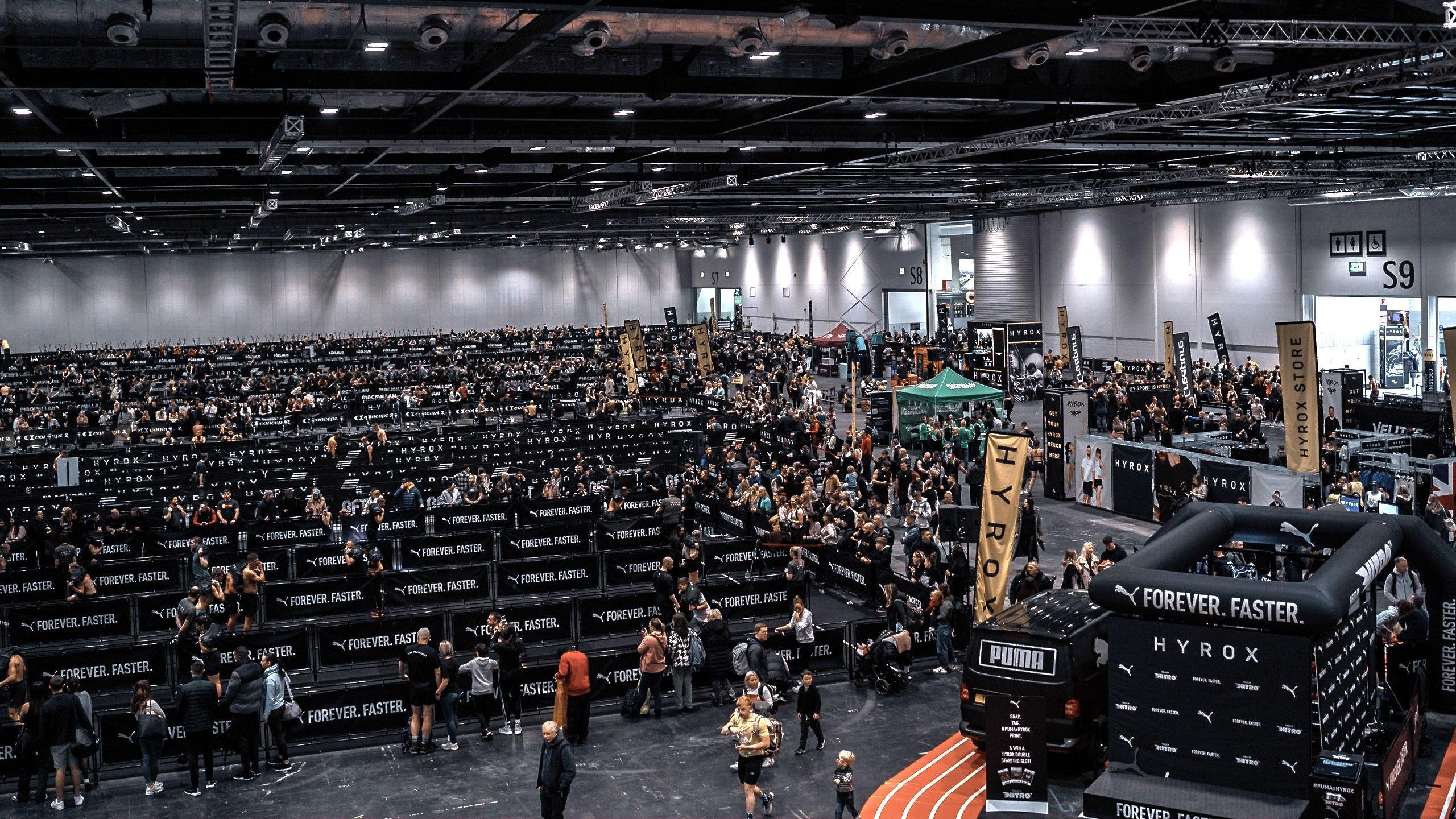 A large arena set up for a race with hundreds of people entering as athletes and spectators.