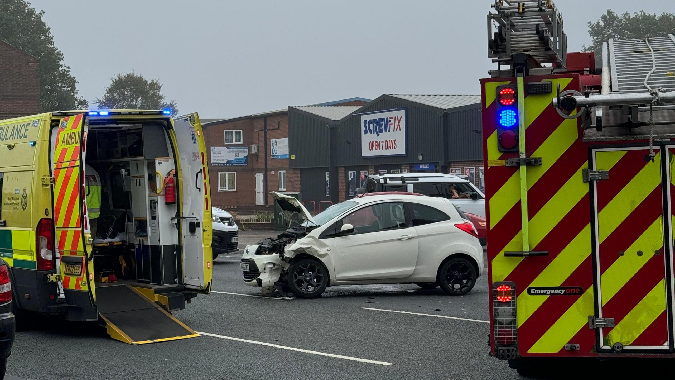 An ambulance and fire appliance parked up near a crashed Ford Ka