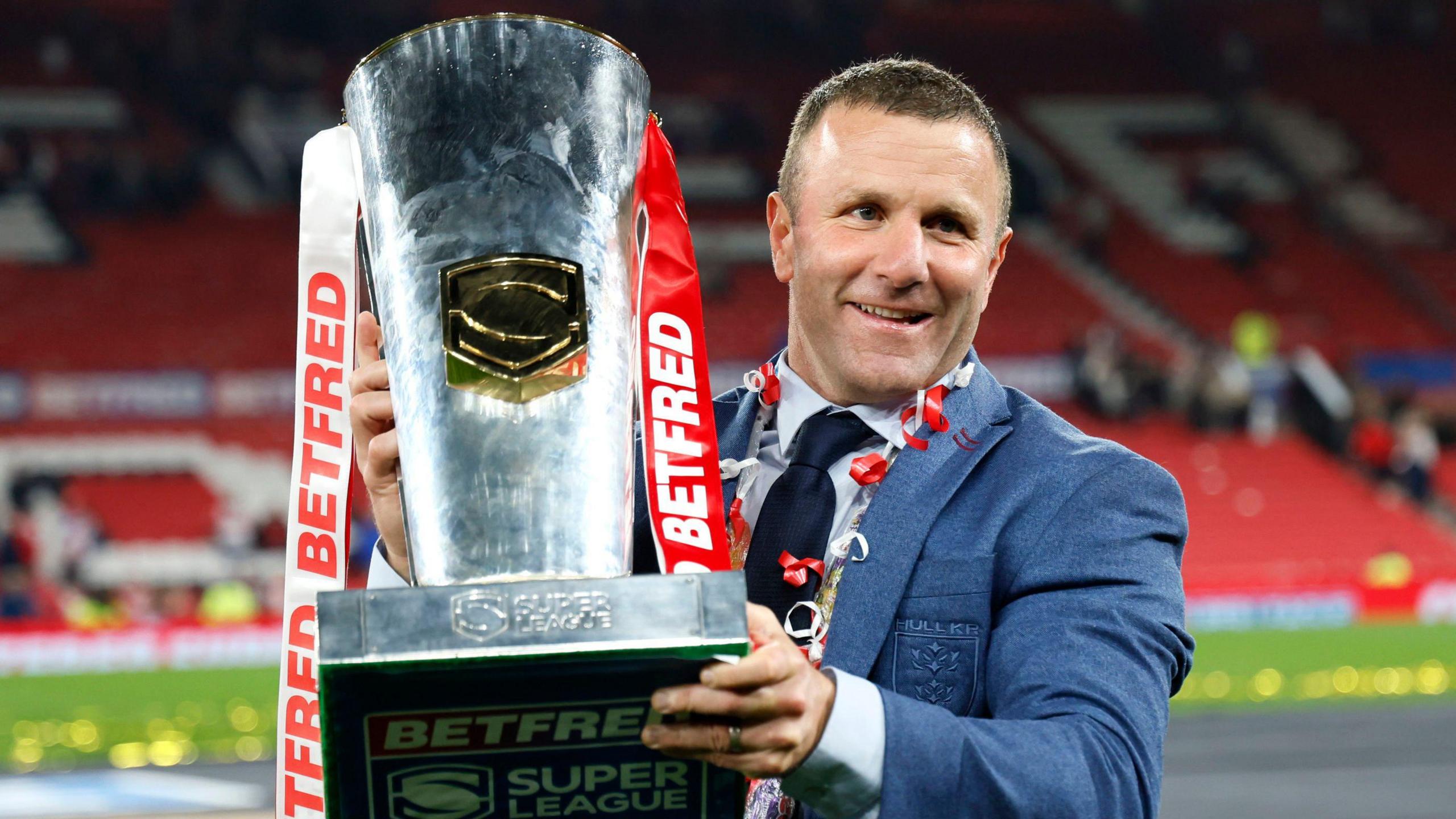 Hull KR coach Willie Peters holds the Super League trophy