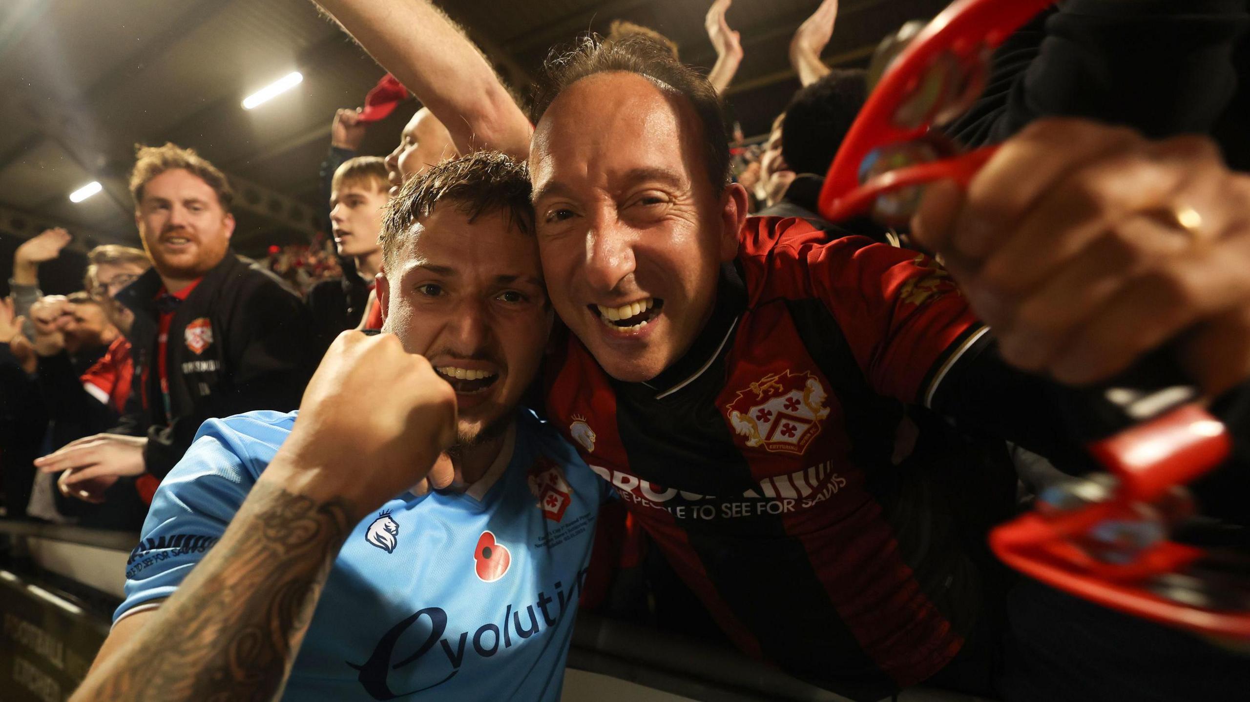 Kettering Town's Lewis White celebrates with supporters after their side’s victory in the Emirates FA Cup first round match at Sixfields Stadium, Northampton