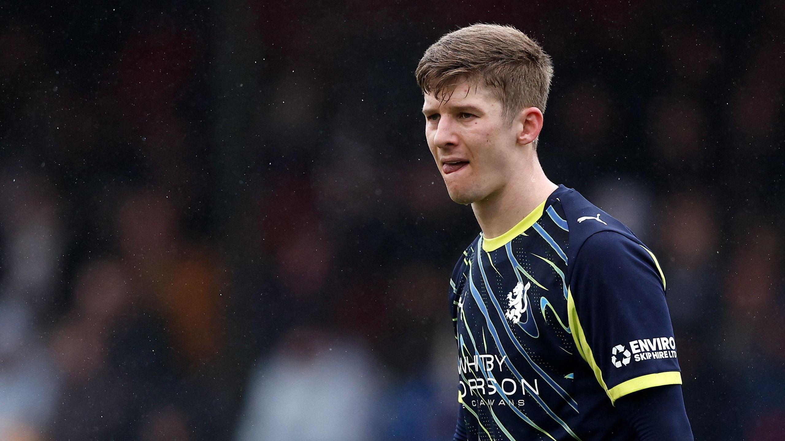 James Connolly in action for Crewe Alexandra. He is wearing a navy blue away shirt