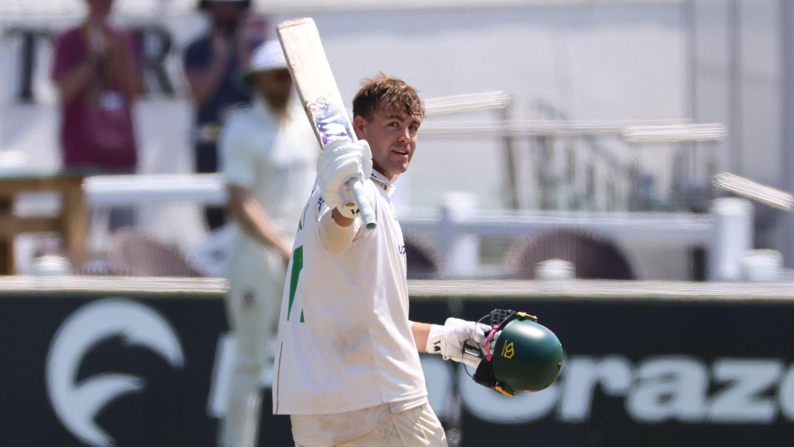 Leicestershire's Louis Kimber raises his bat after hitting 200 runs against Sussex