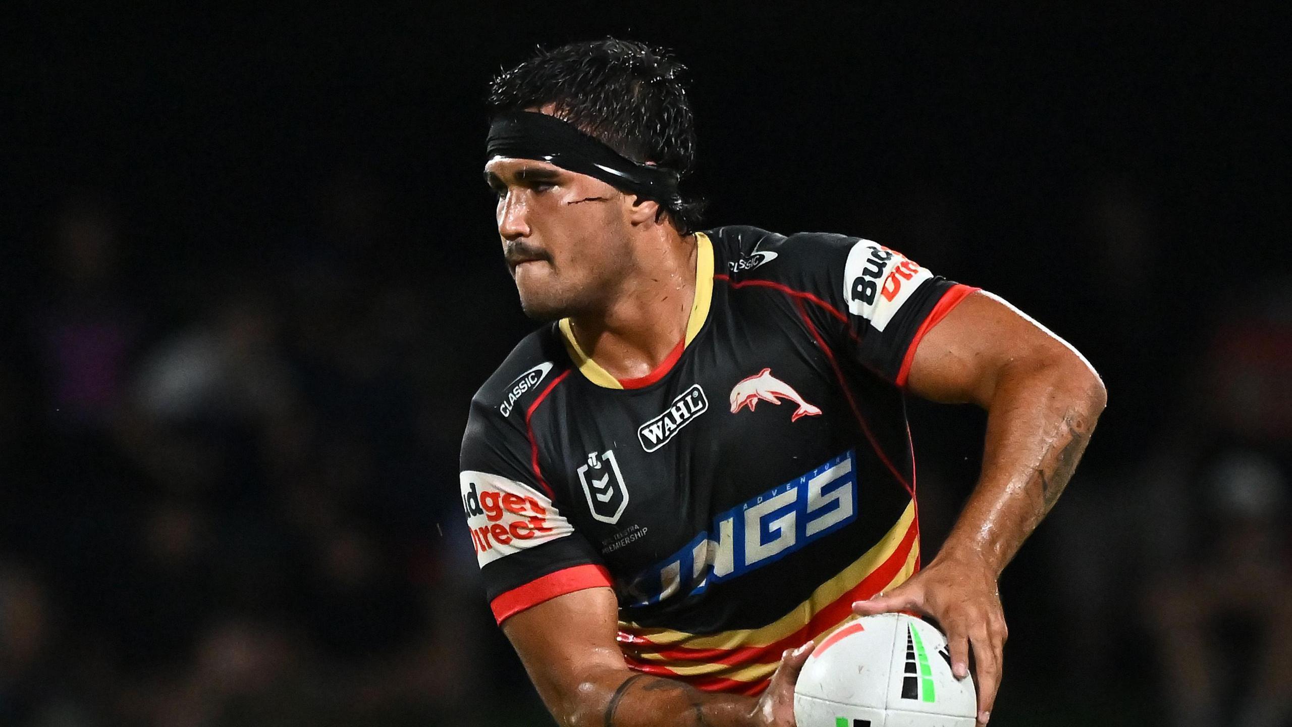 Mason Teague, with black strapping around his forehead, playing for Dolphins in the NRL 