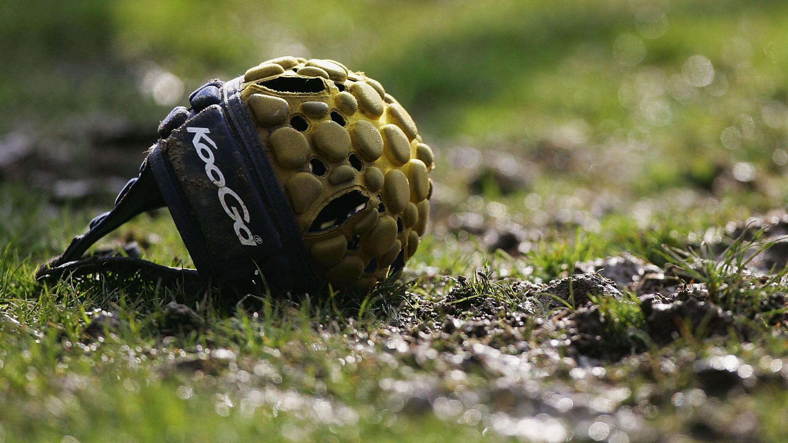 A rugby scrum cap on the ground