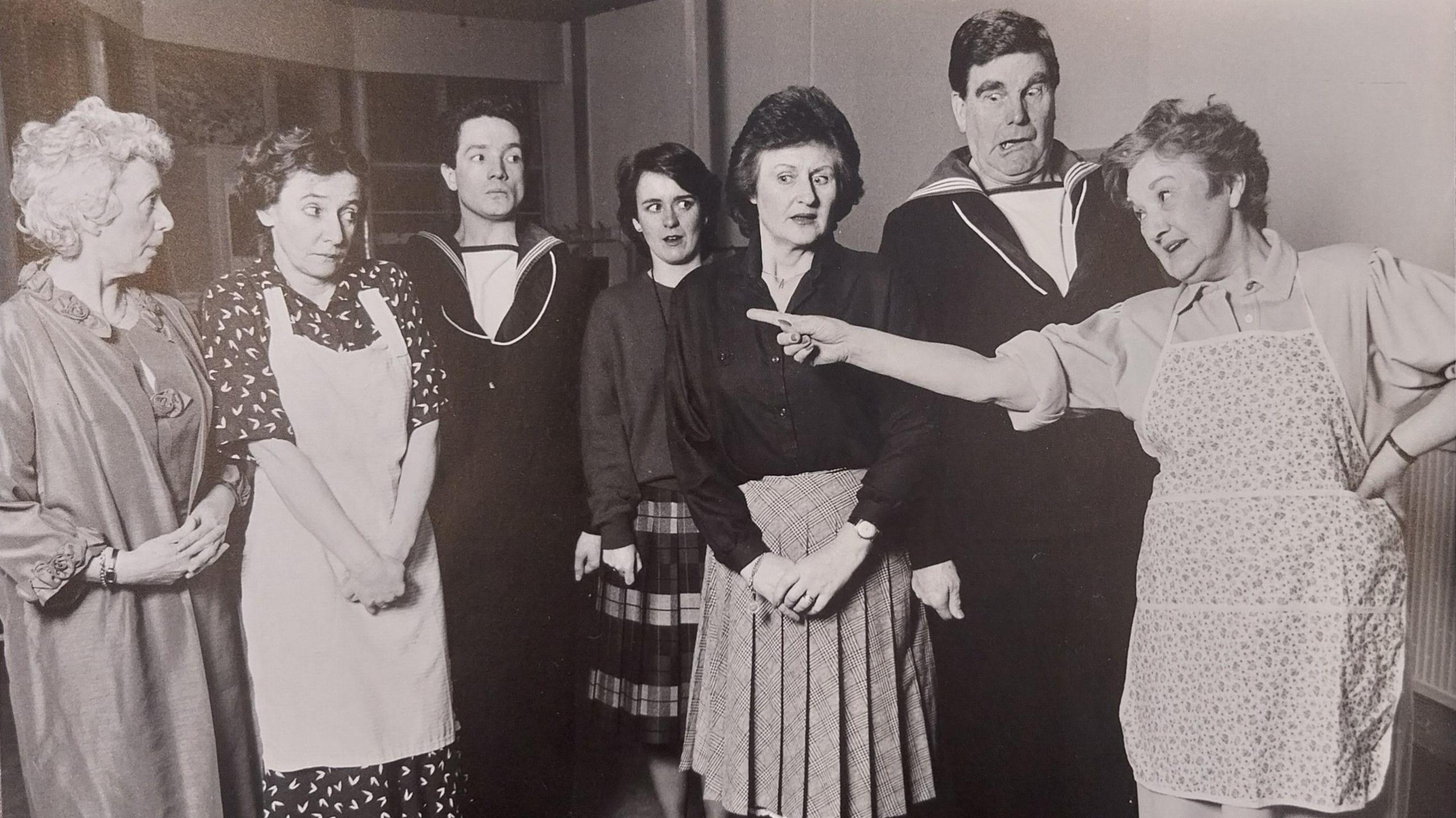 A black and white photo of the PODS cast of Rock-A-Bye Sailor in 1987 dressed in costume