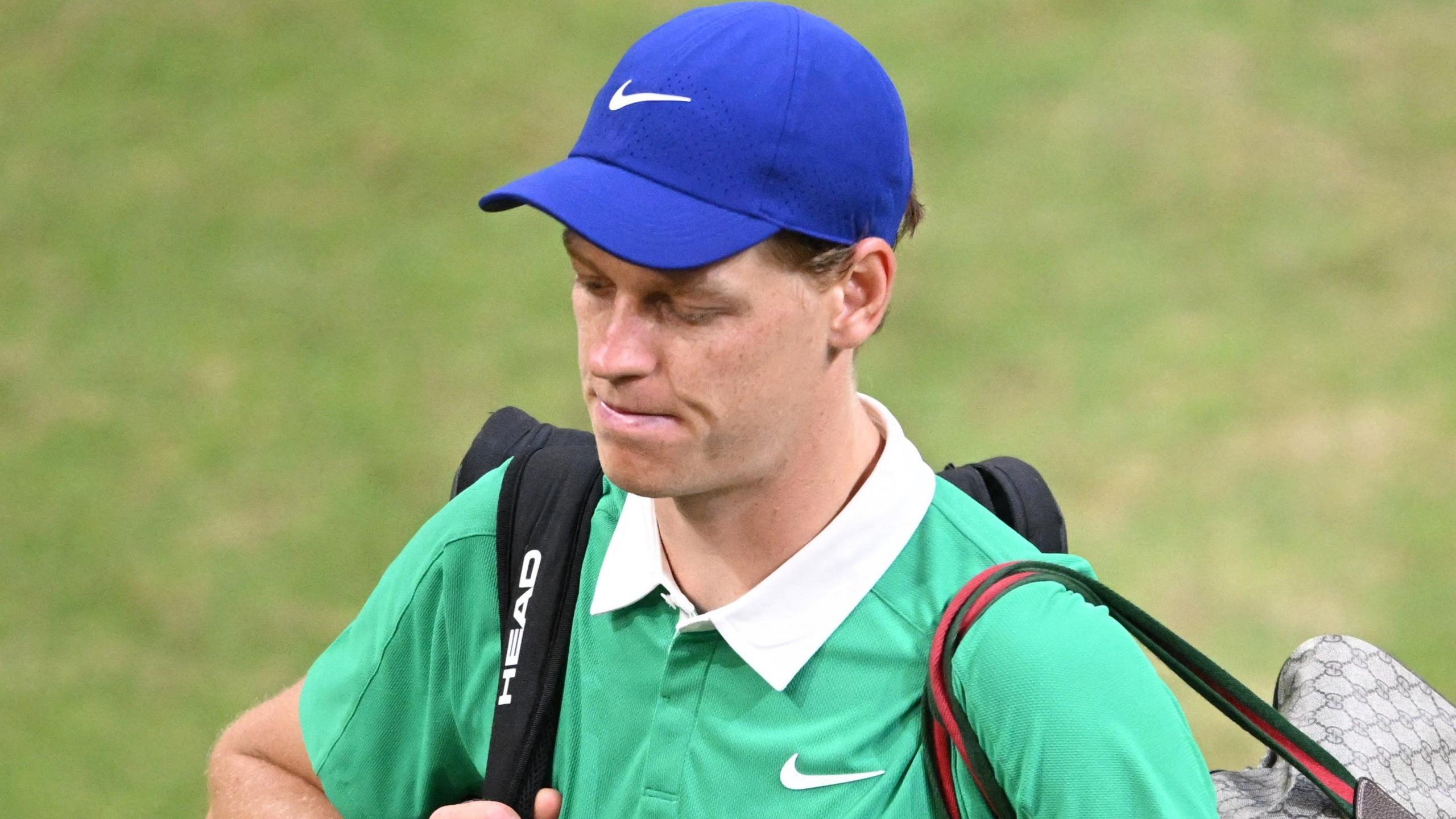 A dejected Jannik Sinner walks off court after his loss to Alexander Bublik in Halle