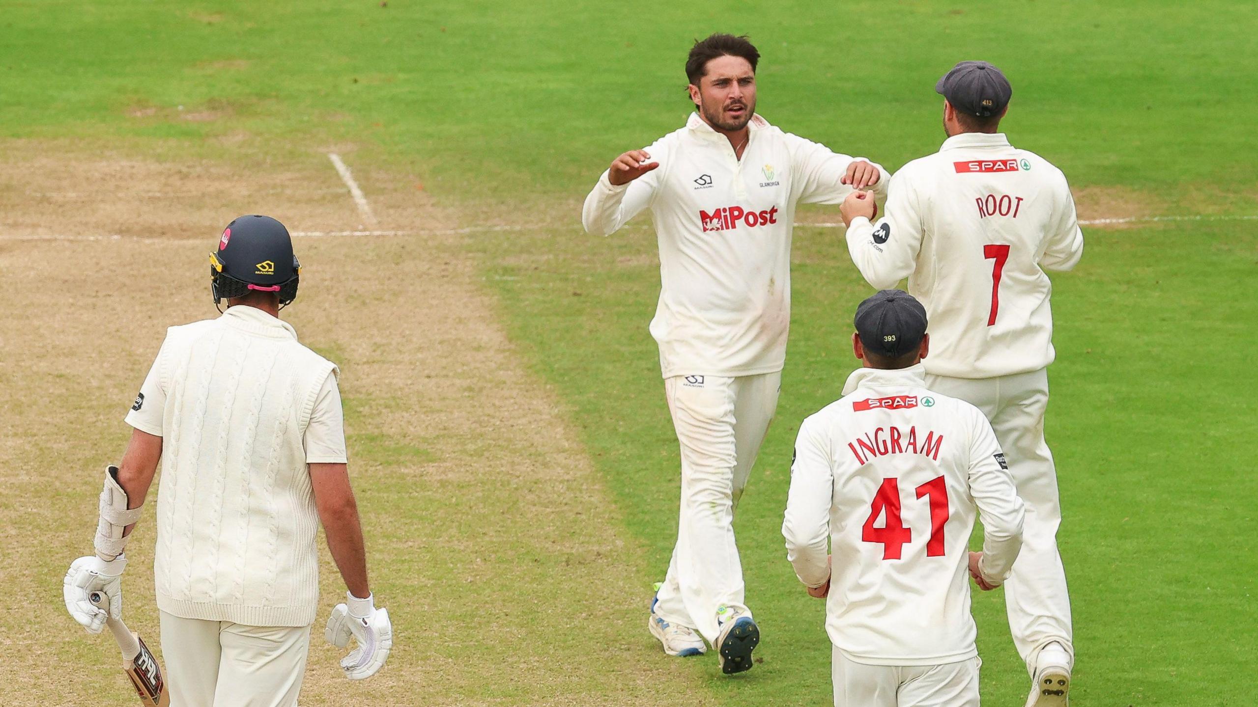 Kiran Carlson and Billy Root celebrate as they combine to dismiss Matt Quinn