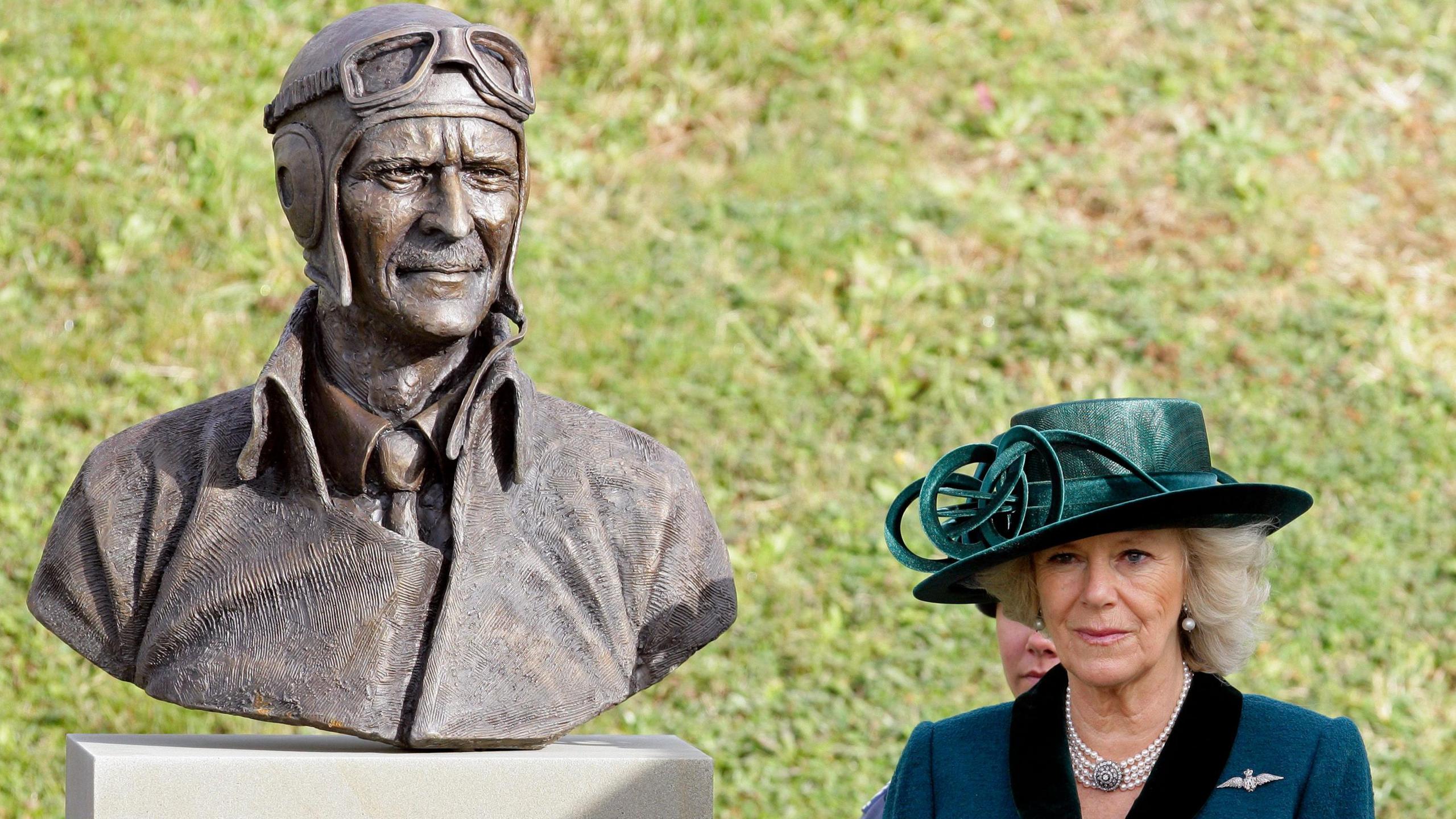Camilla Duchess of Cornwall unveils a bust of Air Chief Marshal Sir Keith Park as she visits the Battle of Britain National Memorial to The Few on October 28, 2010 in Folkestone, England. She wears a green hat and coat, with RAF wings on her right lapel.