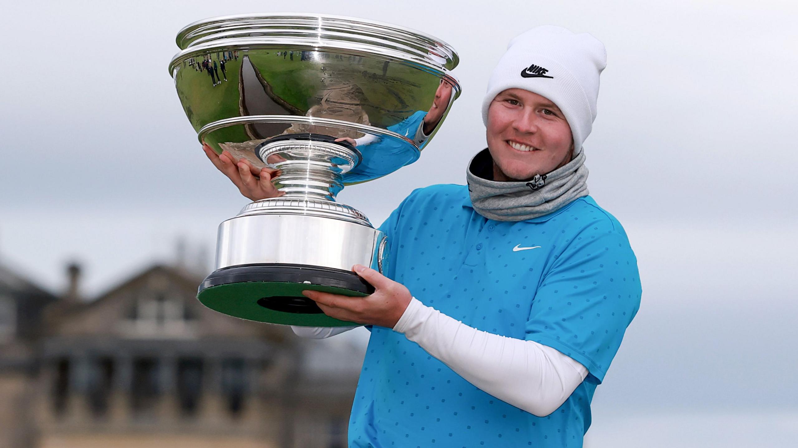 Scotland's Robert MacIntyre poses with the Alfred Dunhill Links trophy on the Swilcan Bridge at St Andrews