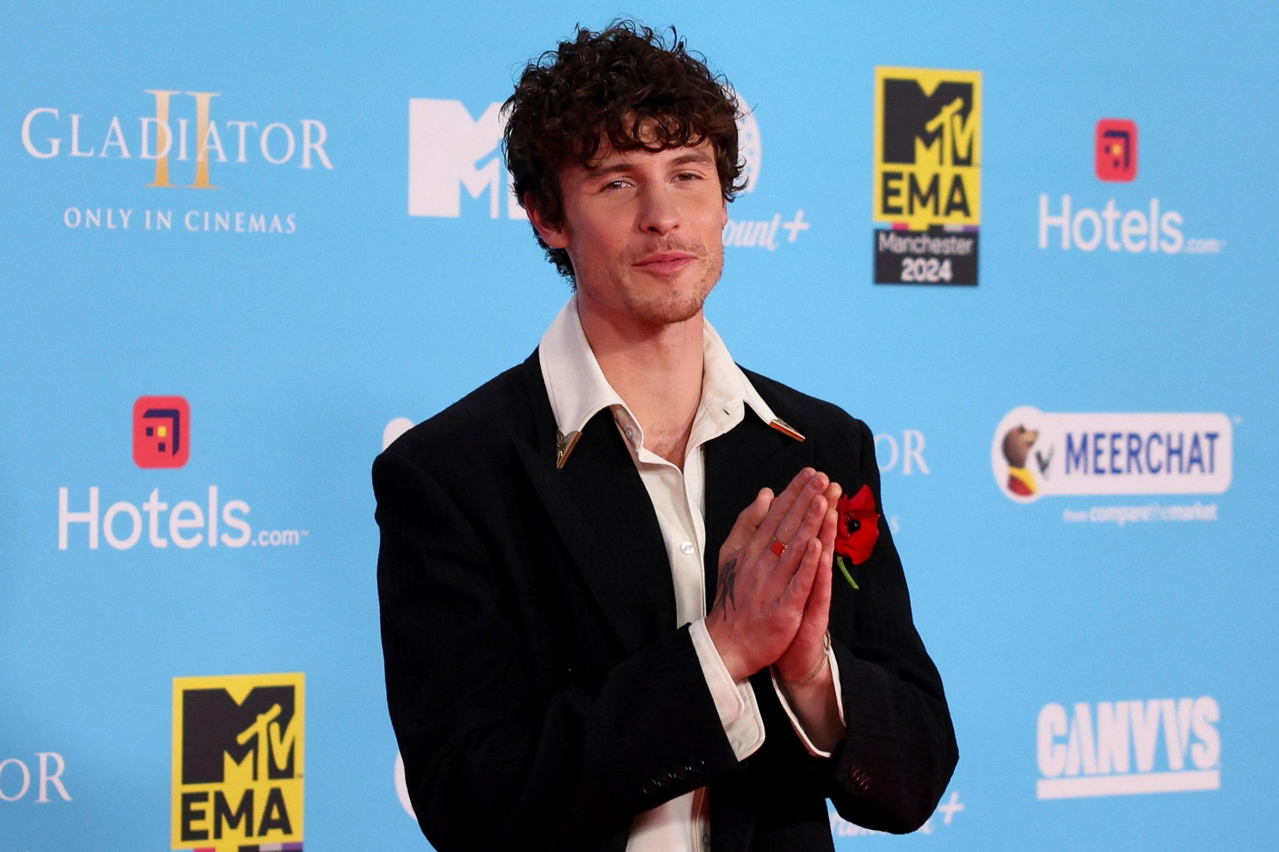 Shawn Mendes with his hands together in a praying pose