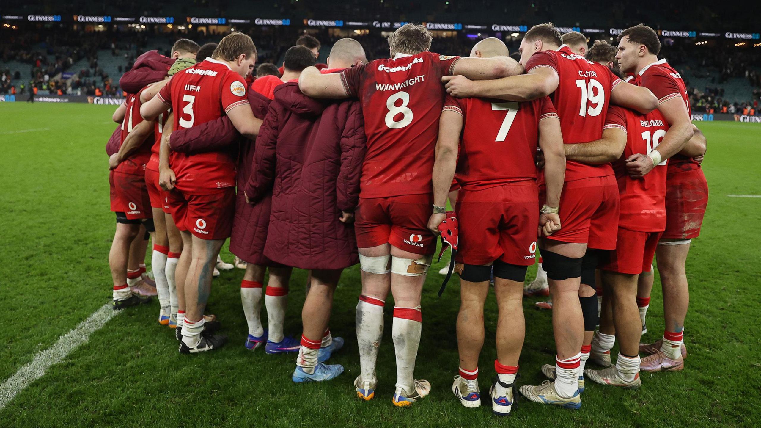 Wales players in a huddle after the 48-7 defeat against England 