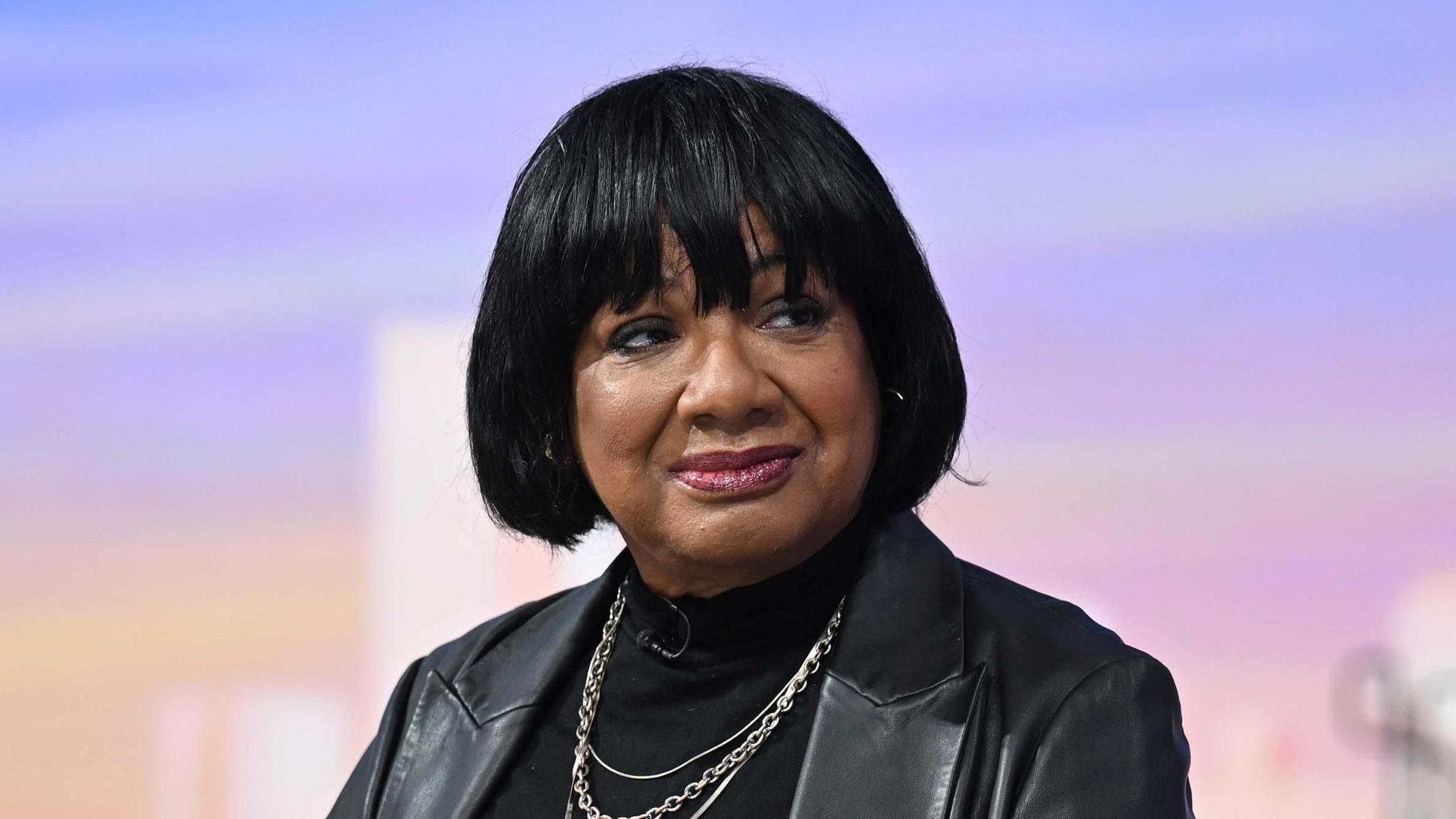 Diane Abbott is pictured wearing a black jacket and jumper on a BBC set.