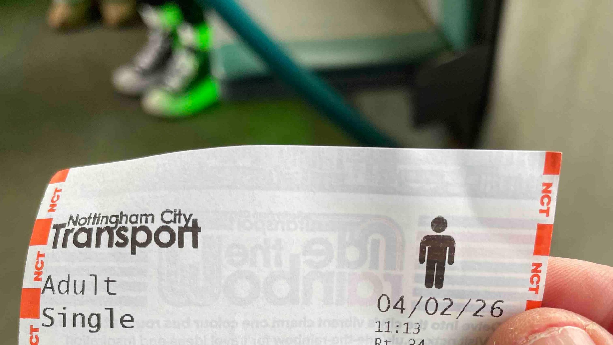 Matt Barlow holding a bus ticket on a bus