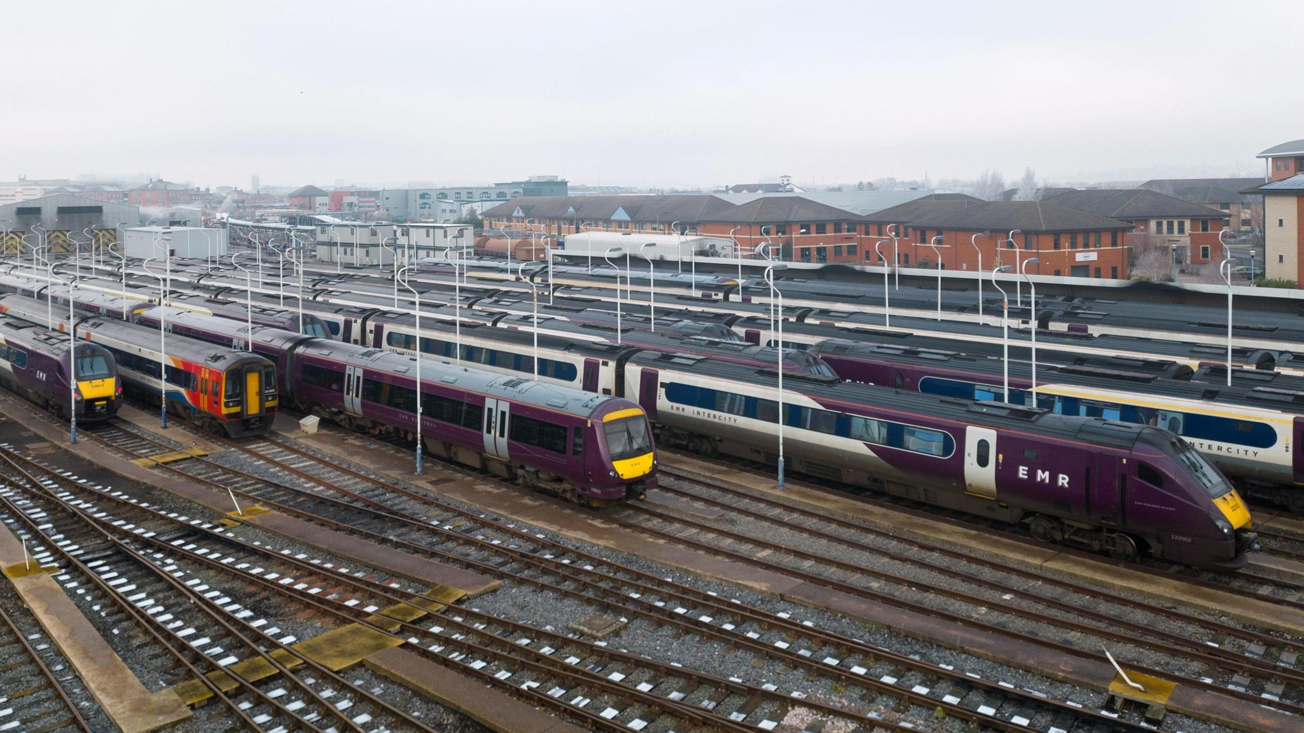 Trains lined up on tracks with EMR livery