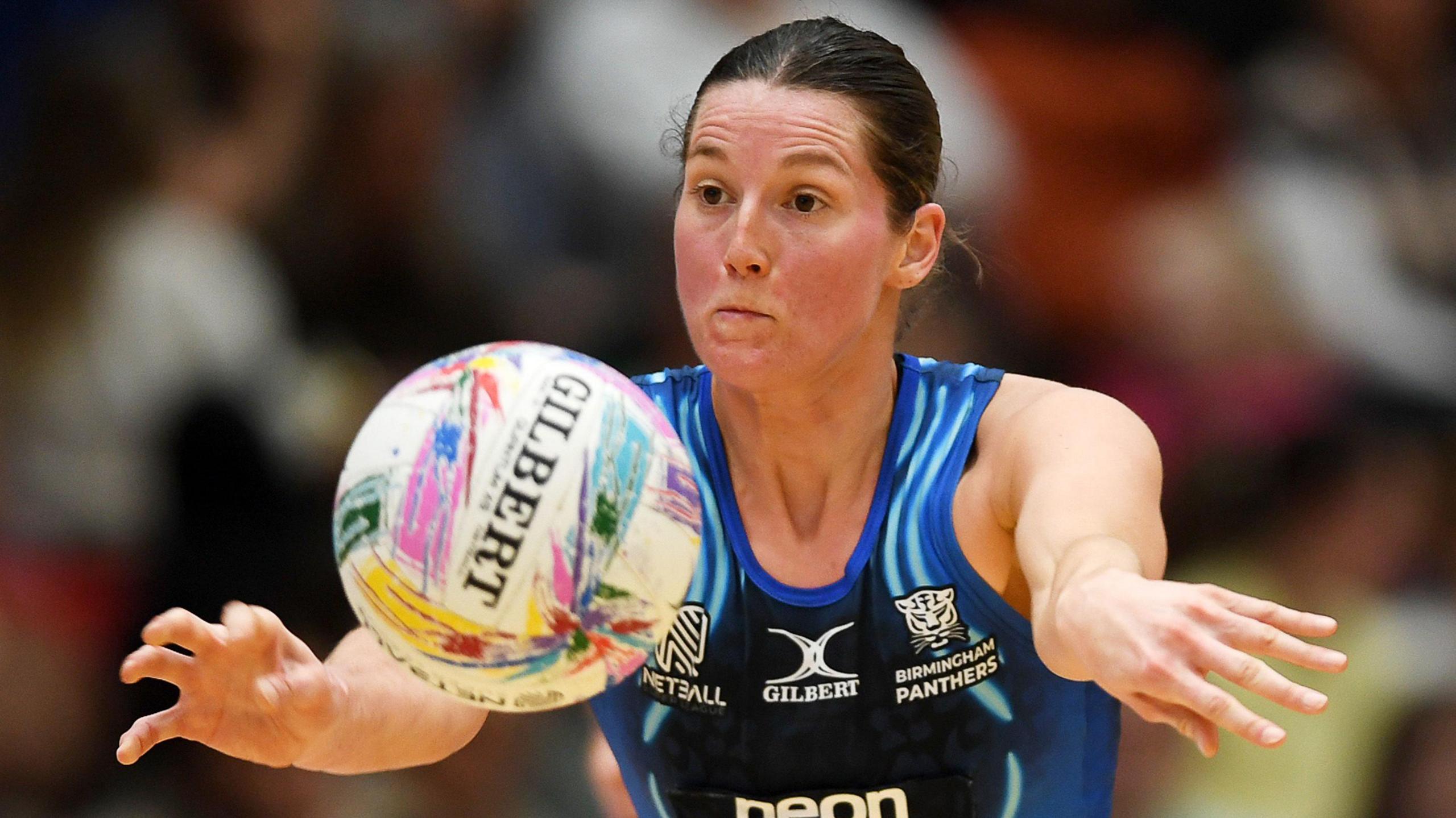Betsy Clark throwing a netball while playing for Birmingham Panthers