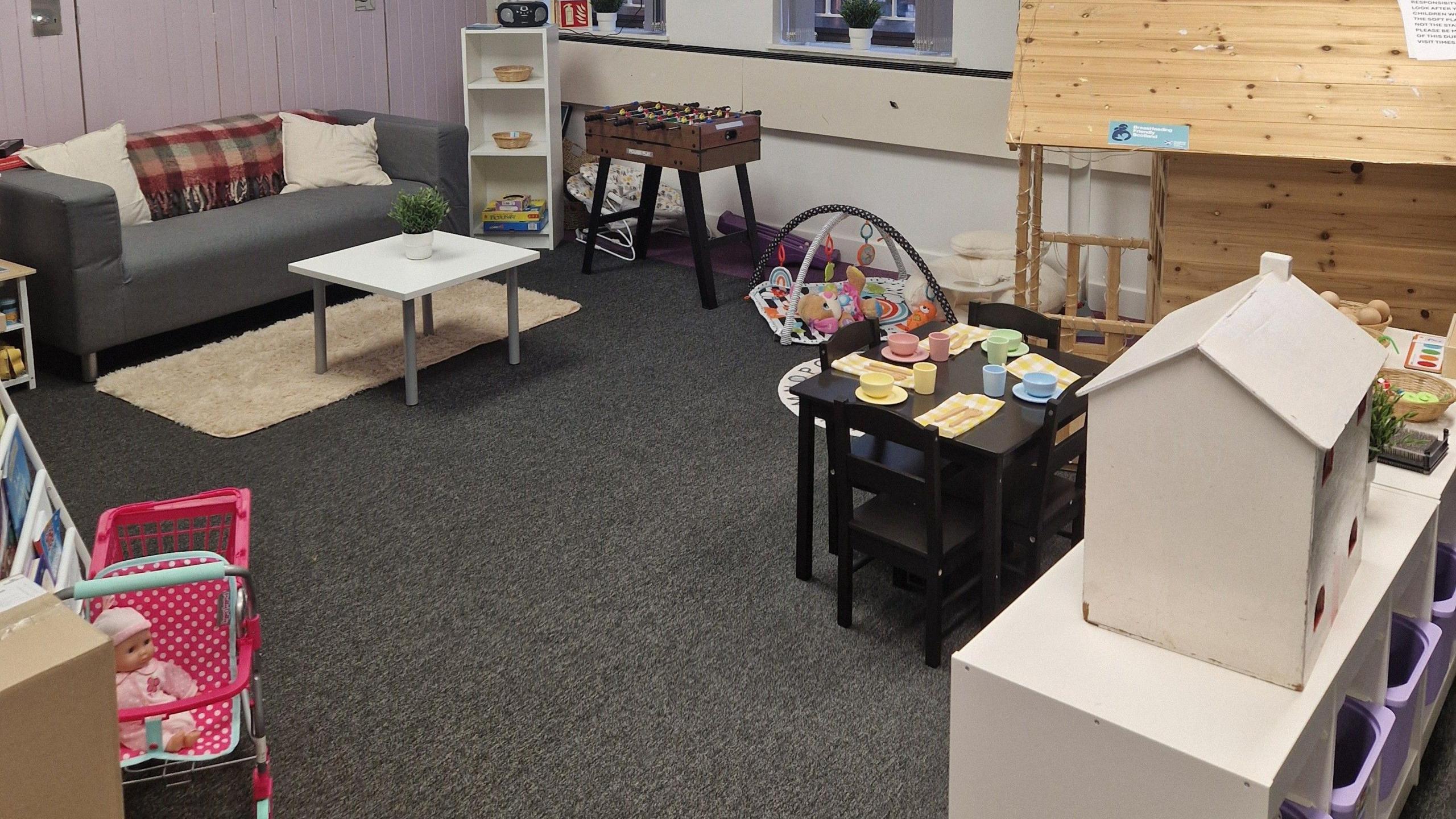 A children's play area with toys and a sofa