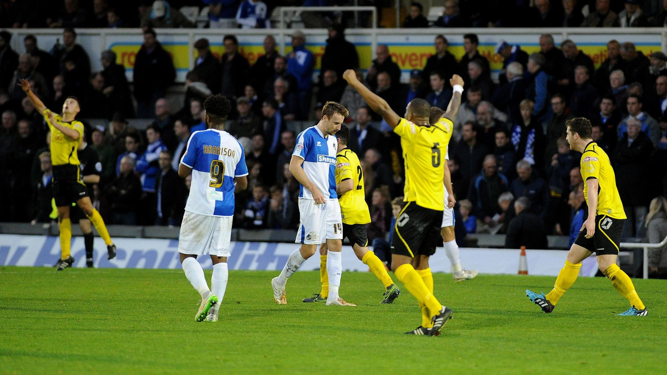 Chesham United players celebrate FA Cup success at Bristol Rovers in 2015 