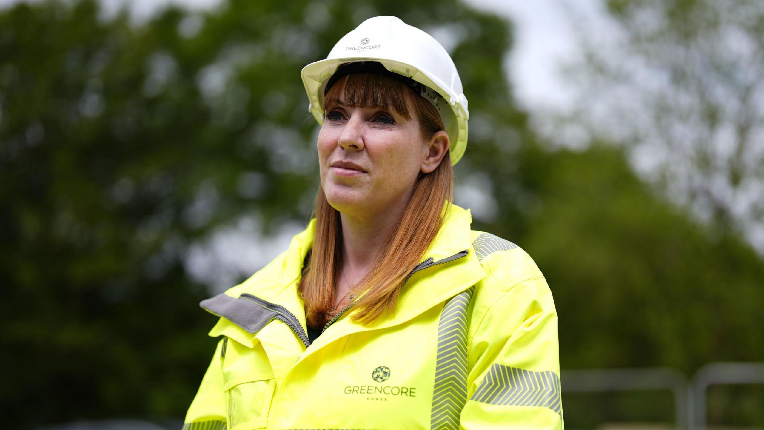 Rayner, wearing a hardhat and hi-vis jacket, during a visit to a new housing development near Didcot, Oxfordshire, last July