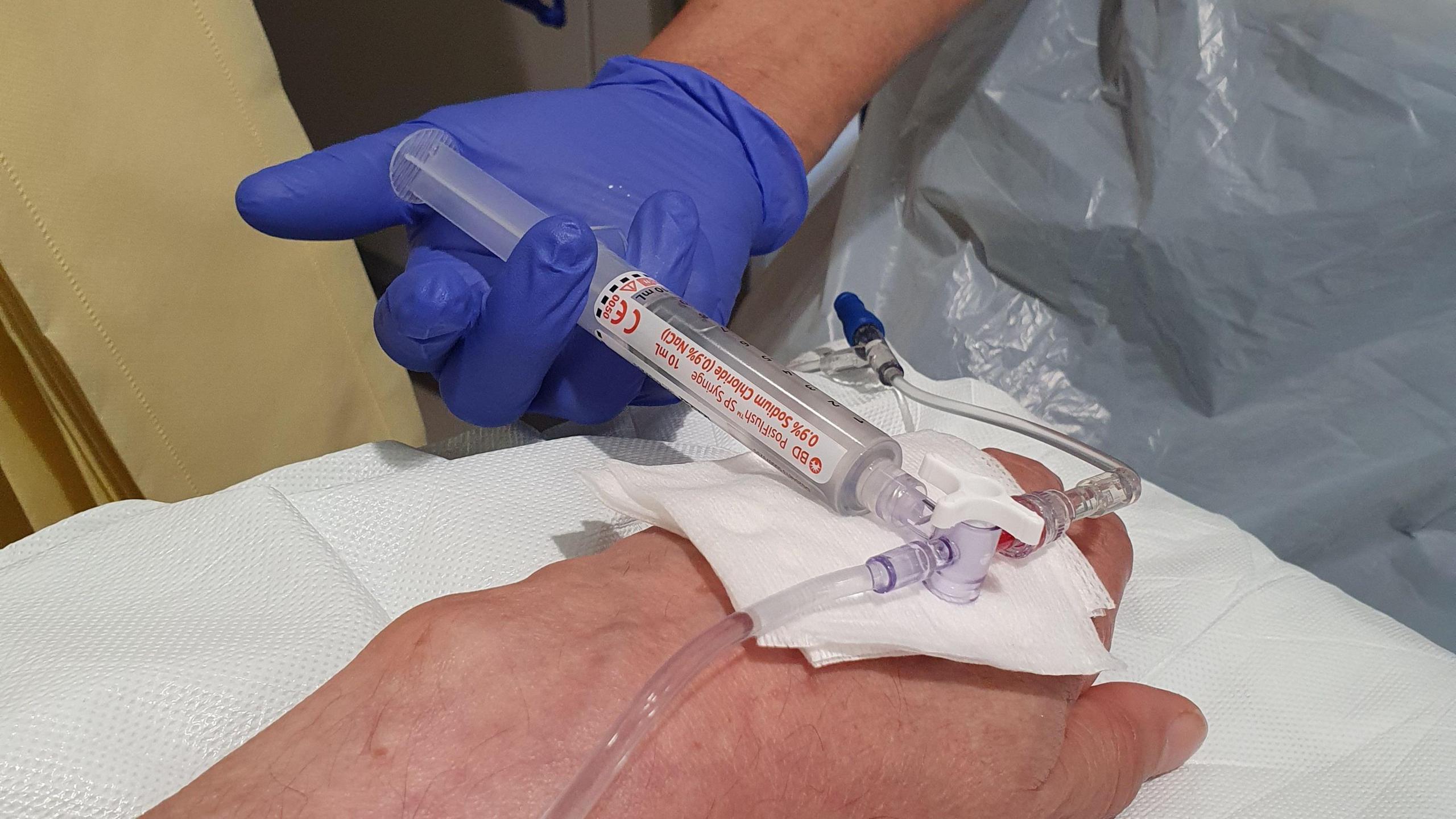 Photograph of a patient receiving a vaccine for bowel cancer 