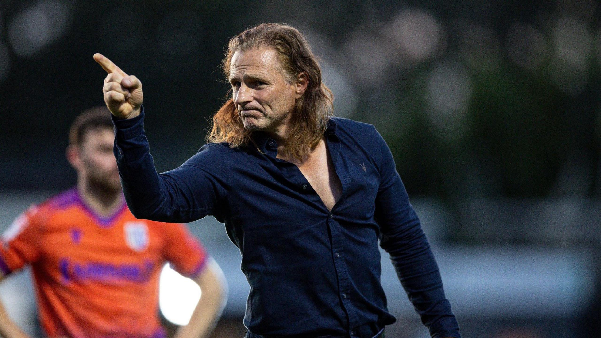 A photo of Gillingham boss Gareth Ainsworth pointing