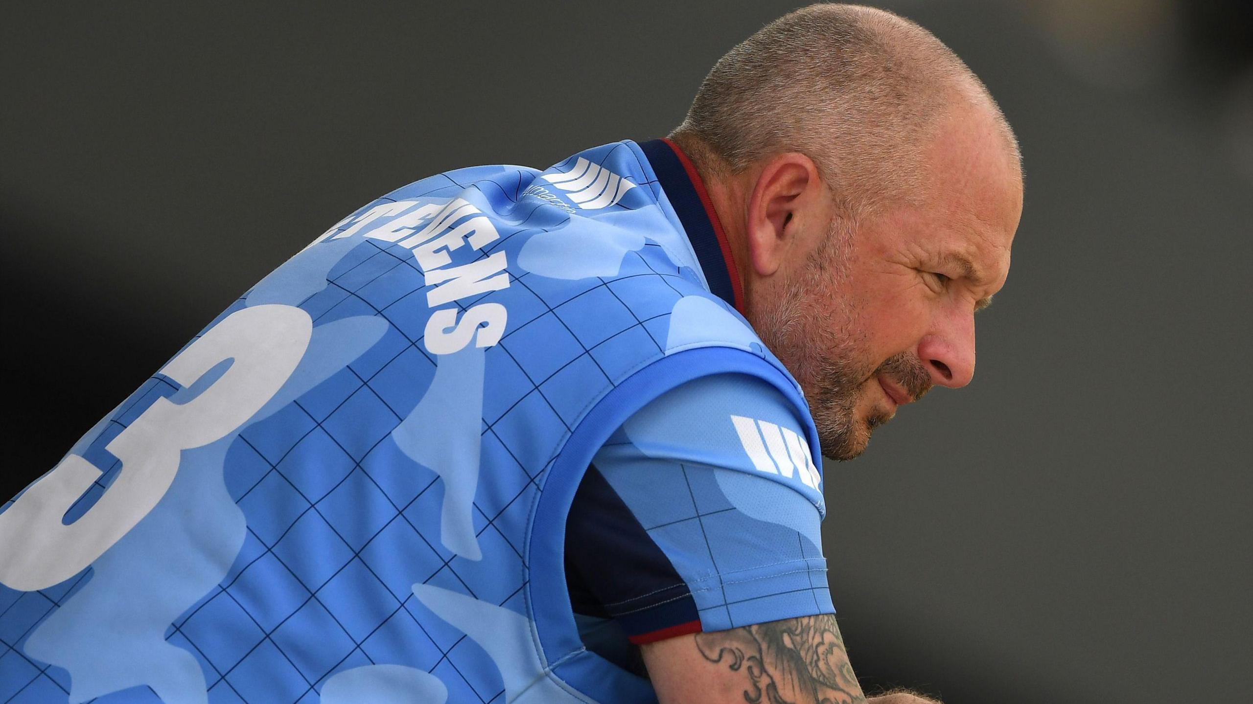 Darren Stevens, hunched over while wearing Kent's blue kit with "Stevens - 3" on the back