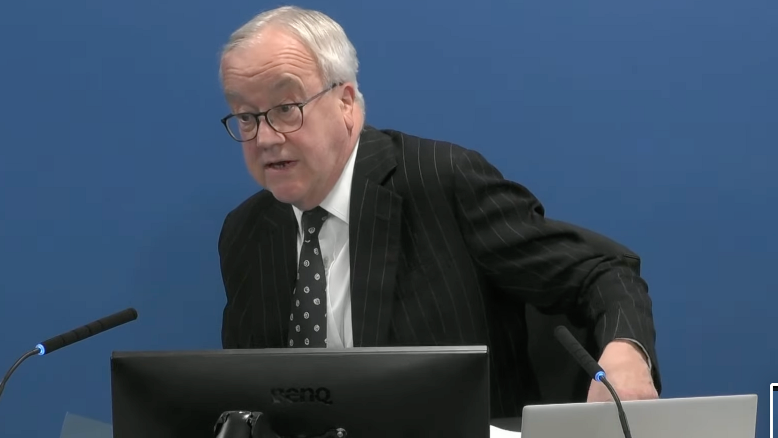Man in shirt and tie, wearing glasses 