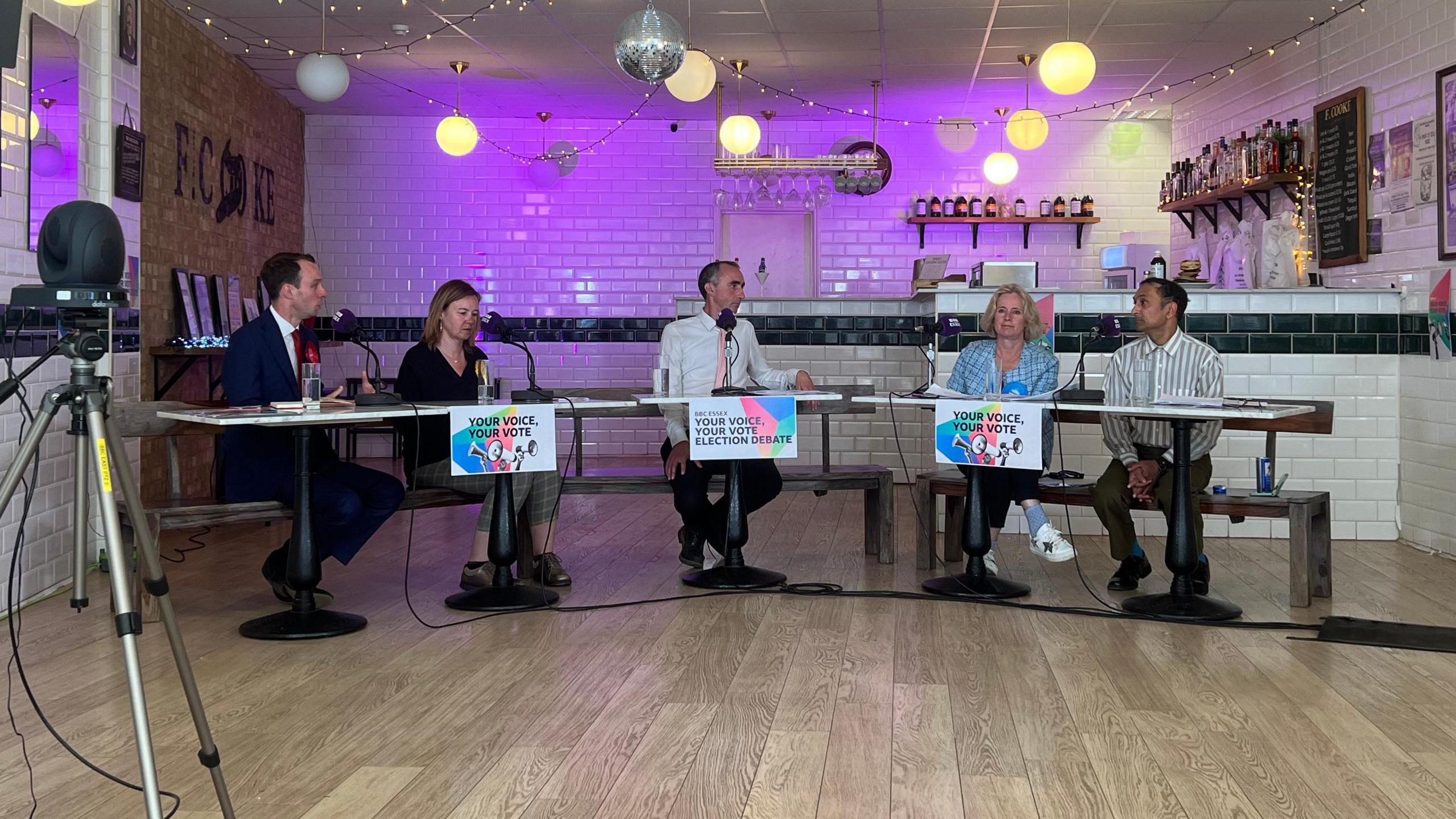 Men and women wanting to be Chelmsford MP sitting on benches in a pie and mash shop