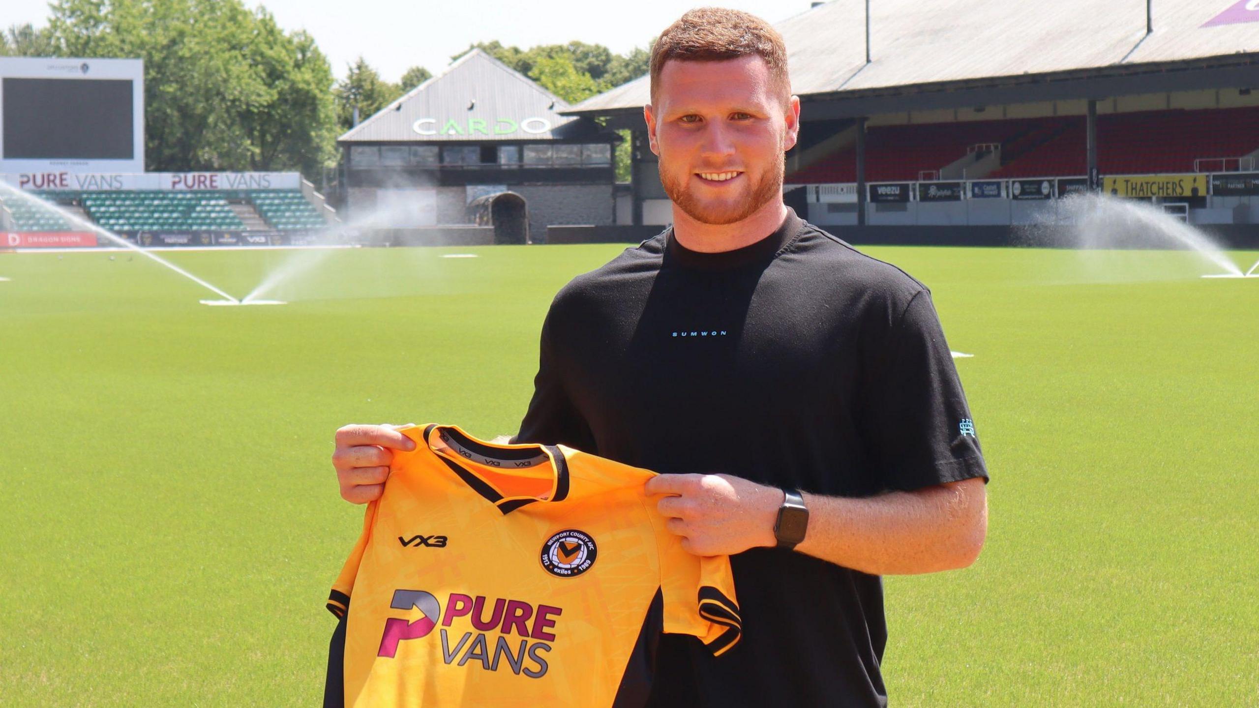 Lee Jenkins holds up the Newport shirt