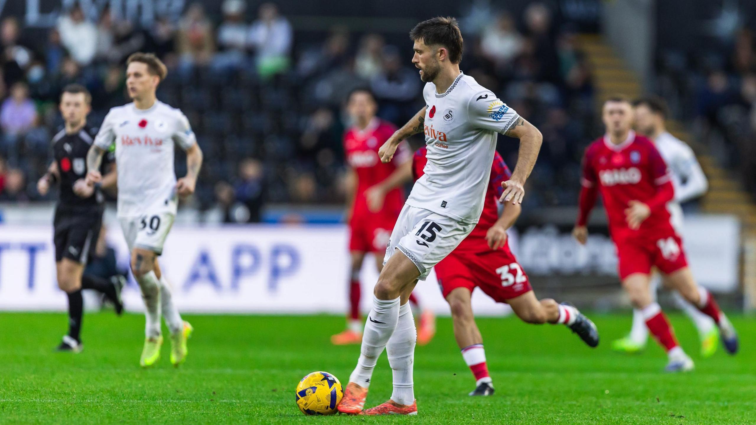 Cameron Burgess passes the ball during Swansea's game against Ipswich 