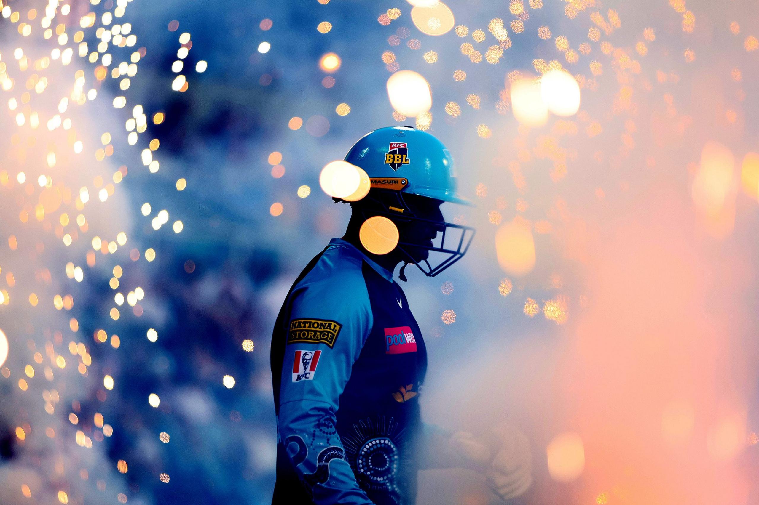 With fireworks in the background, Usman Khawaja of the Heat walks out for the BBL match between Brisbane Heat and Hobart Hurricanes at The Gabba, on January 16, 2025, in Brisbane, Australia