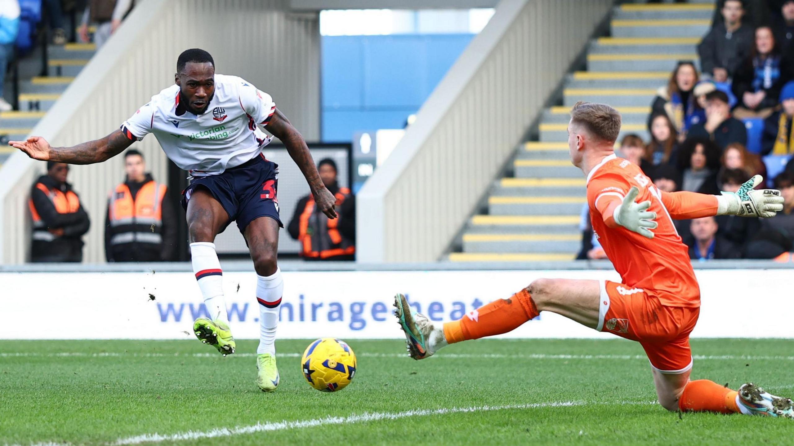 Corey Blackett-Taylor slots home past AFC Wimbledon goalkeeper Nathan Bishop