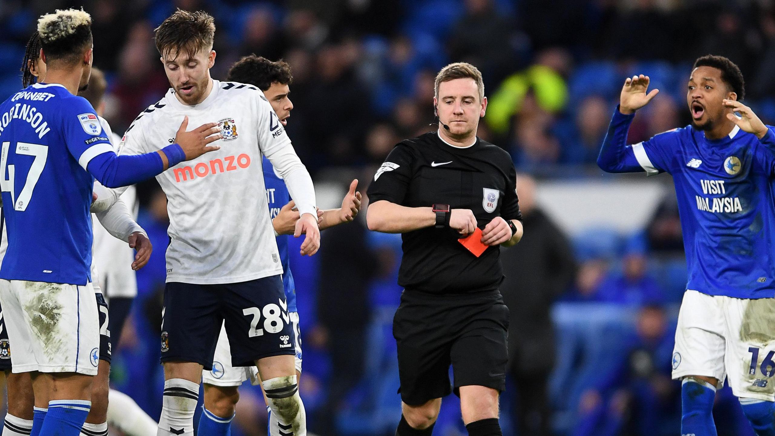 Referee James Durkin shows a red card to Callum Robinson of Cardiff