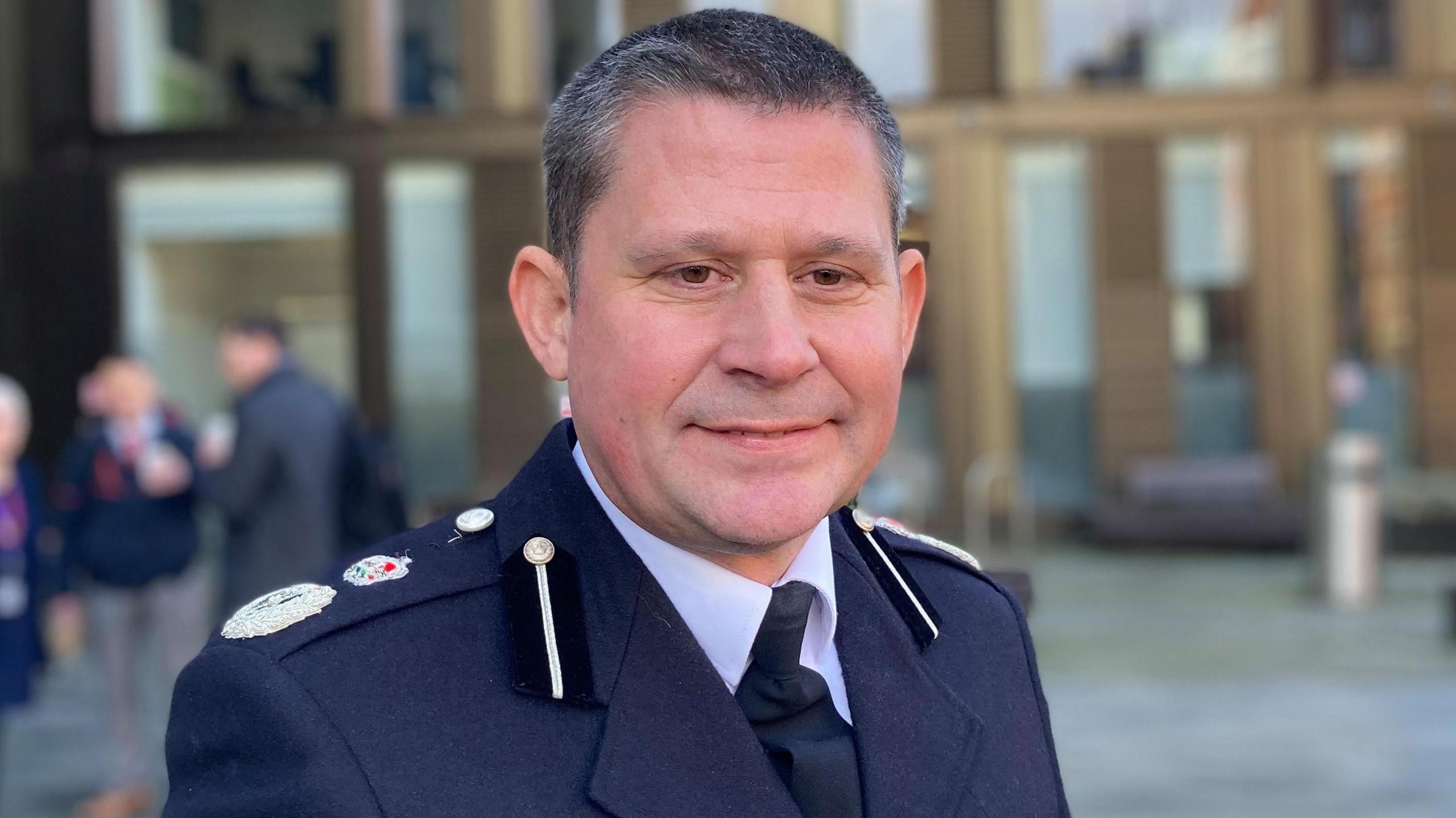 Man in police officer uniform outside office building