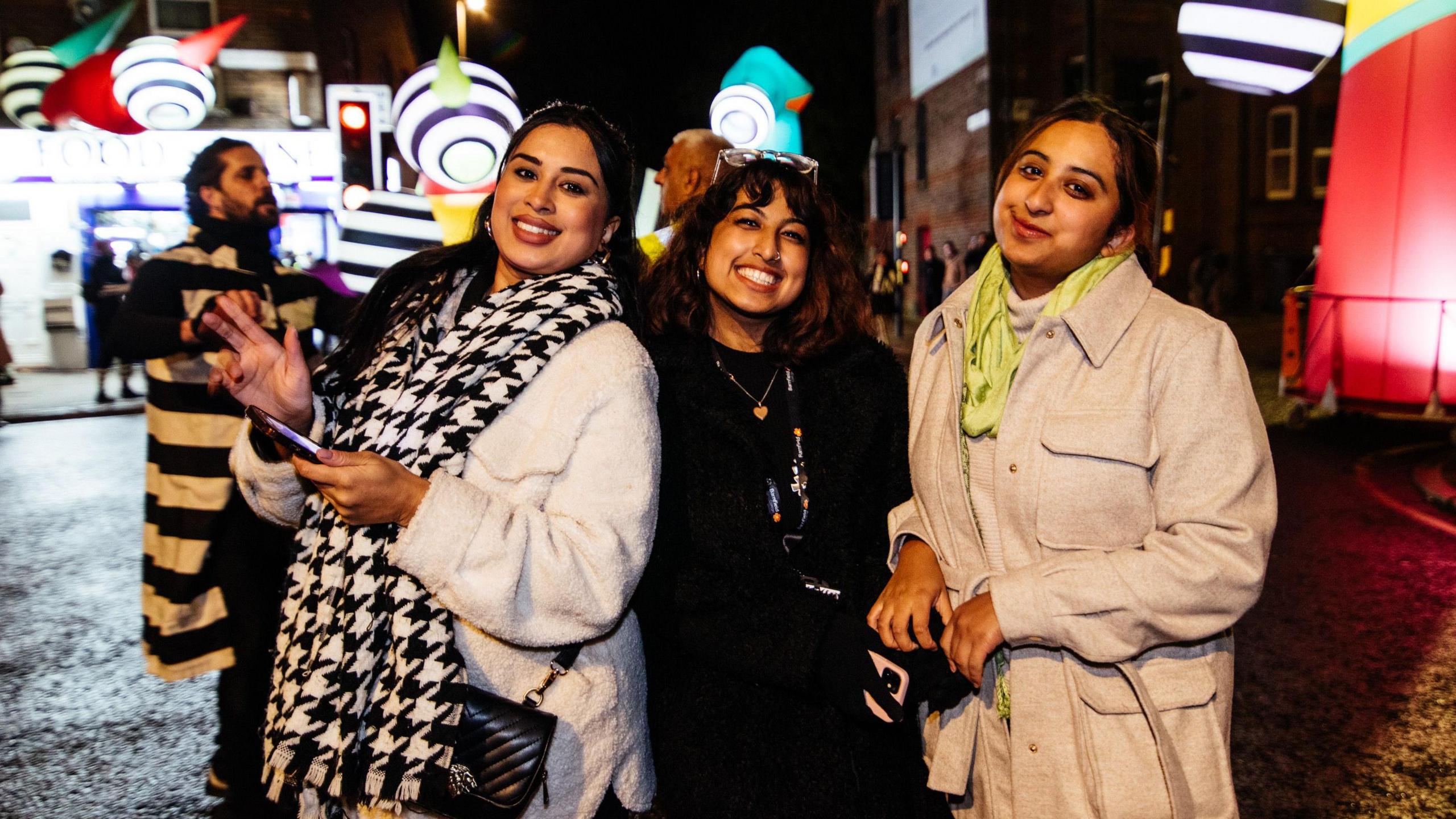 Three women watching a Luton light display