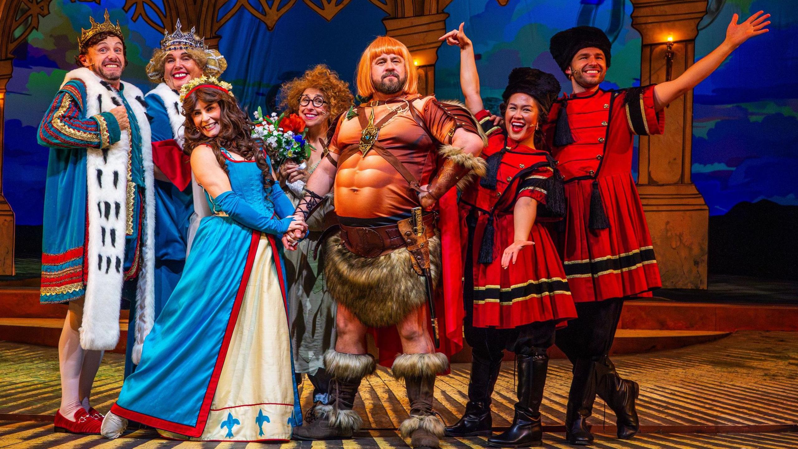 The Legend Of Rooney's Ring - [L-R] Liam Tobin, Lindzi Germain, Emma Grace Arends, Keddy Sutton, John May, Latesha karisa, Adam McCoy - all in colourful medieval costumes on stage 