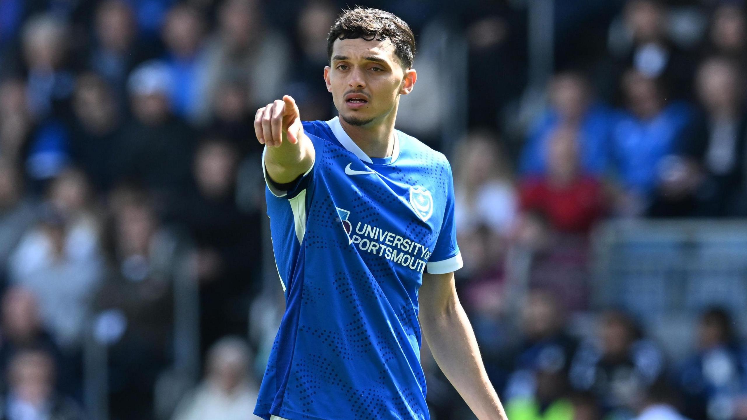 Andre Dozzell points while playing for Portsmouth 