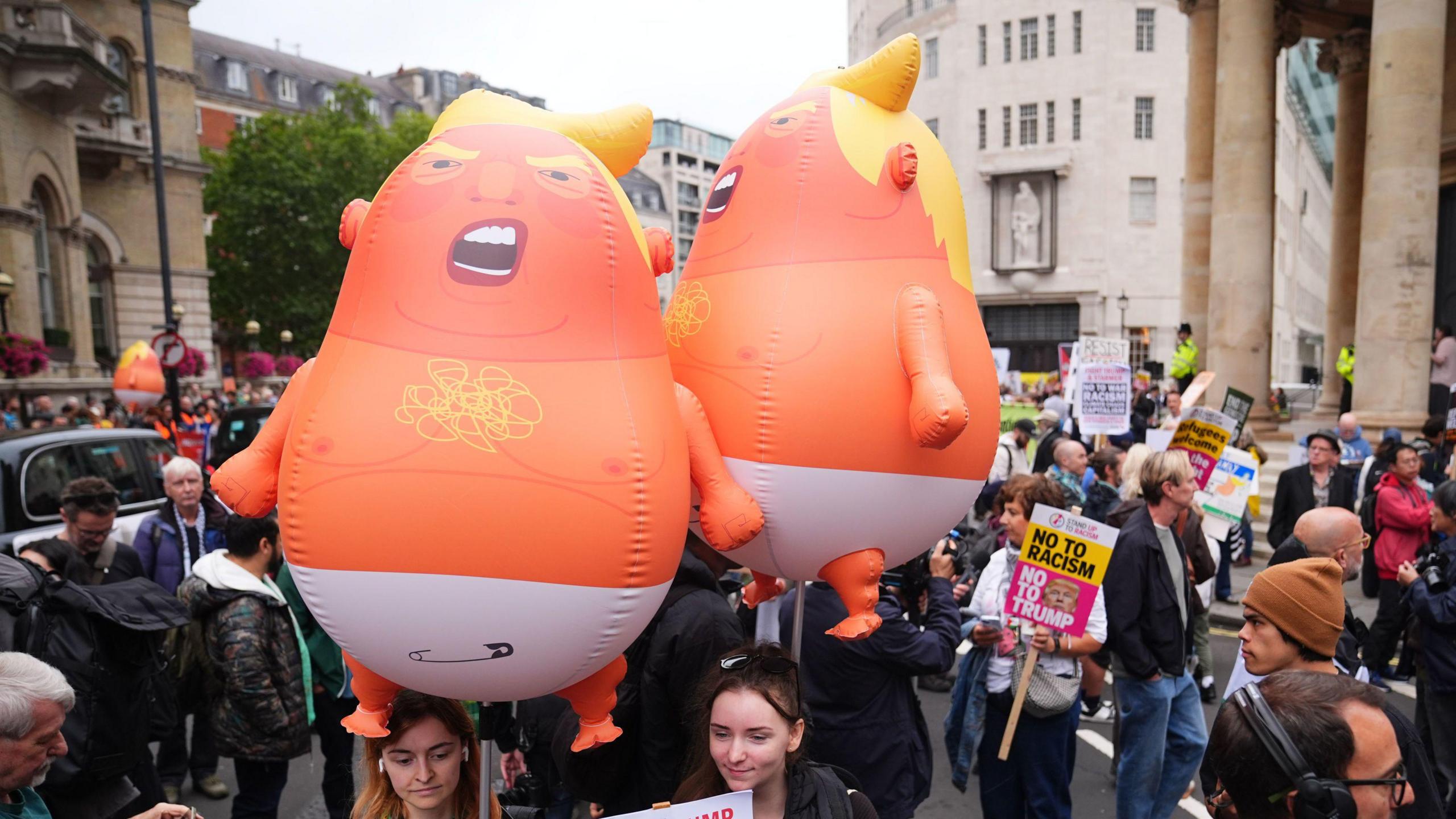 Stop Trump Coalition campaigners carry balloons of US President Donald Trump portrayed as a baby while taking part in a protest march from the BBC's headquarters in Portland Place to Parliament Square on Wednesday 17 September 2025.