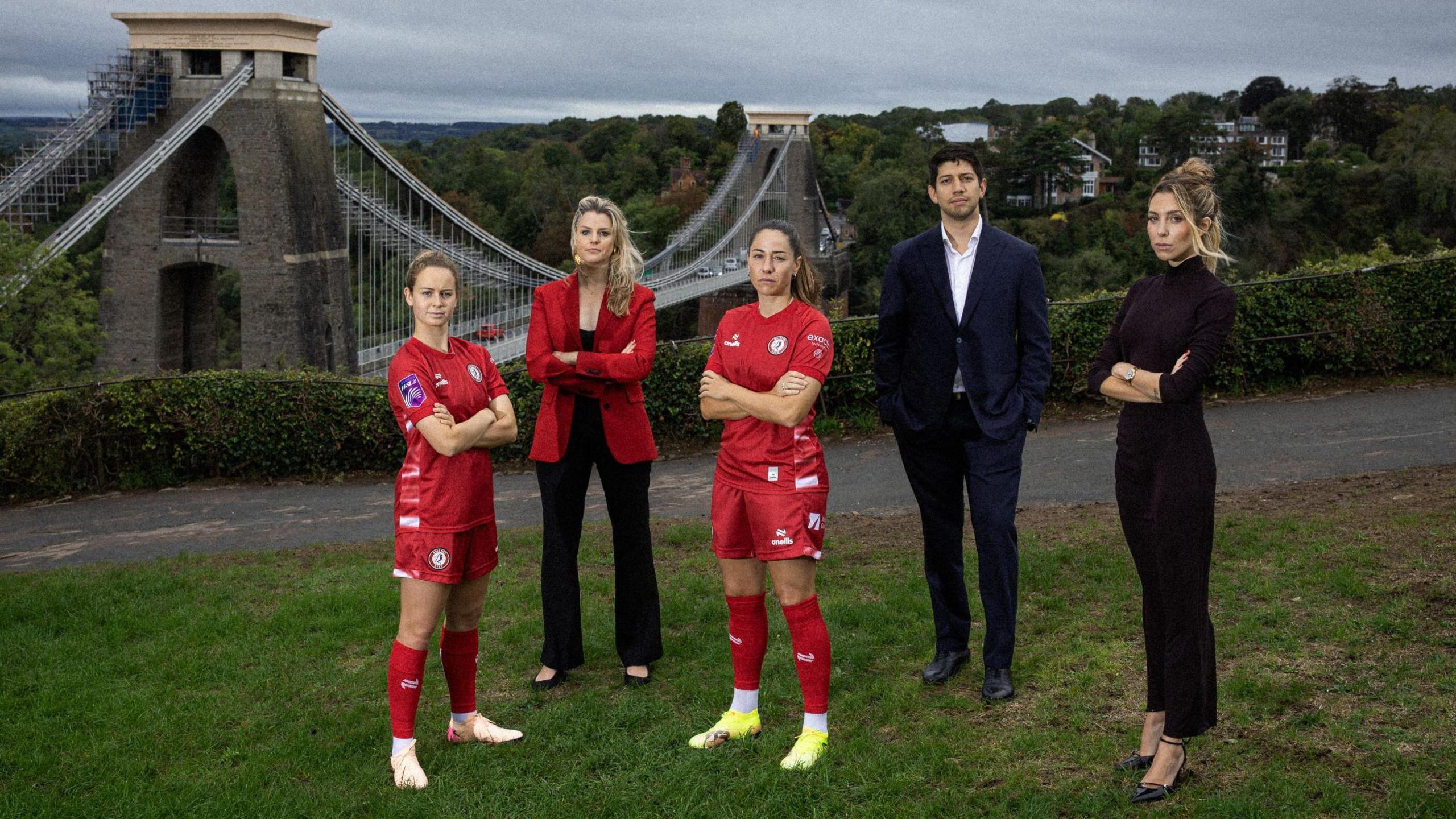 (Left to right) Emily Syme, Bristol City Women, Hannah Haynes, Mercury13 chief strategy officer, Vicky Losada, Bristol City Women captain, Mario Malave and Victoire Cogevina Reynal, Mercury13Founder's and co-CEOs all standing in front of the Clifton Suspension Bridge 