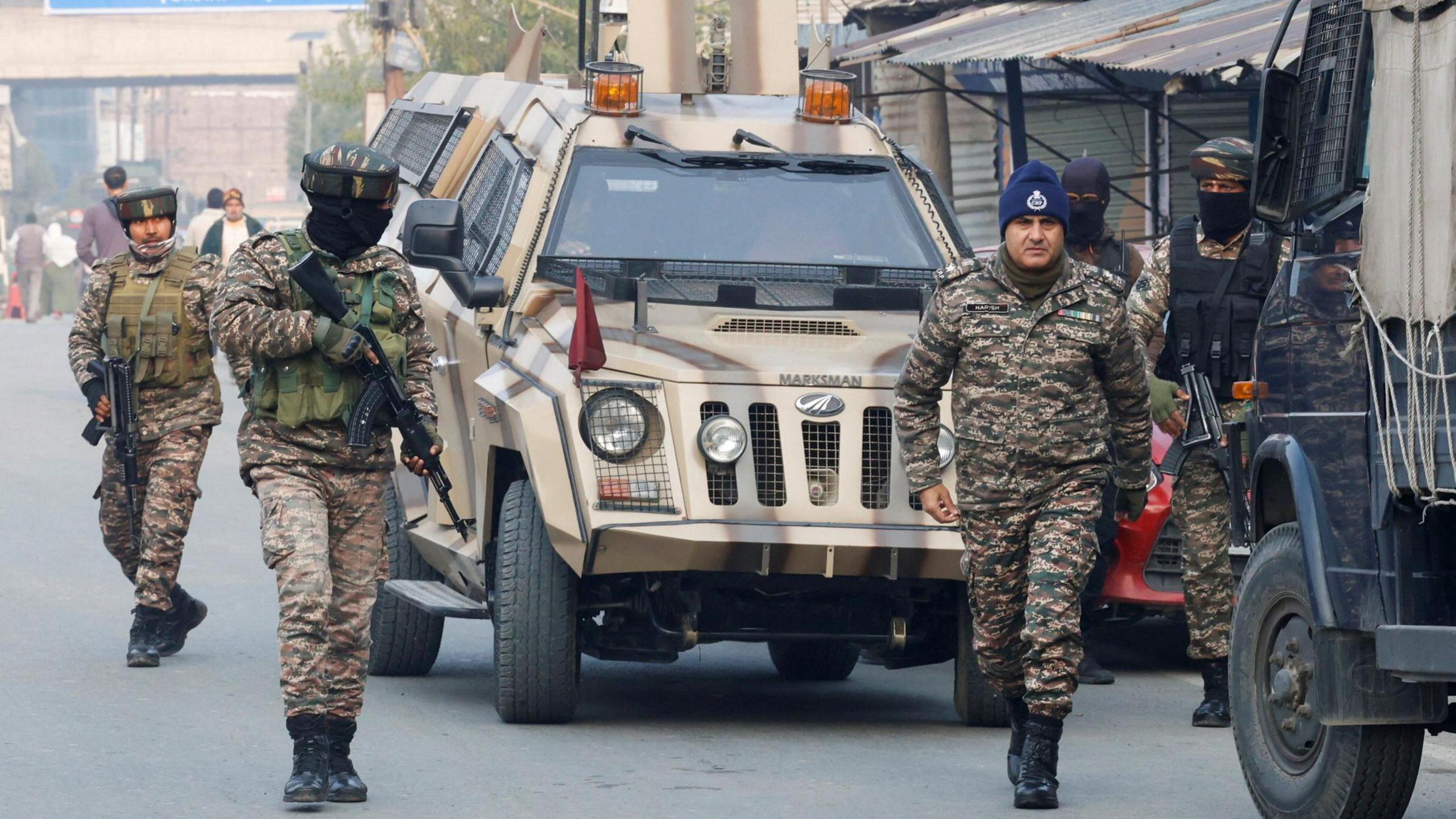 Four members of India's security forces wearing military fatigues arrive outside a police station in Srinagar, Indian Kashmir on 15 November 2025. 