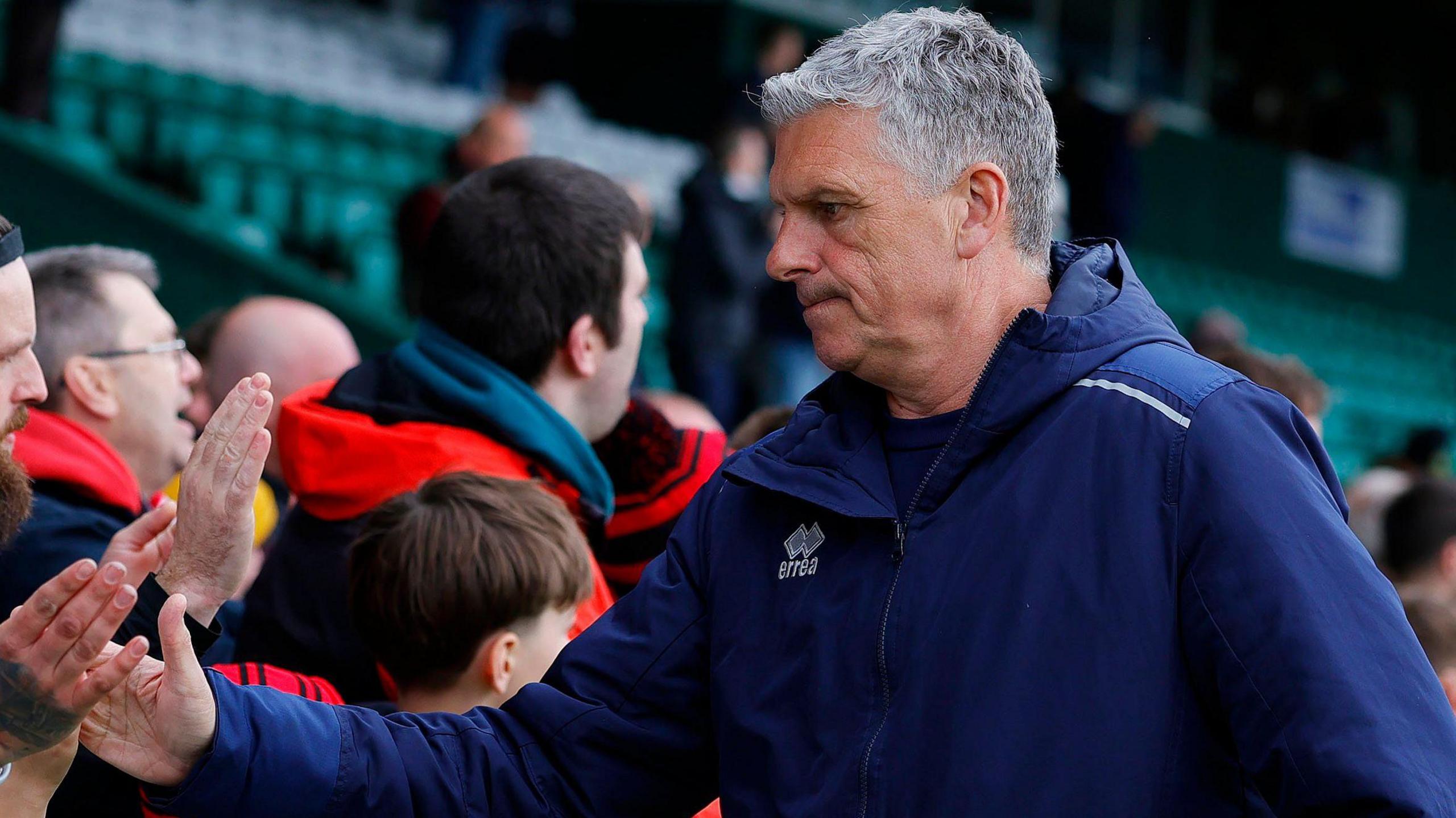 John Askey shakes supporters' hands