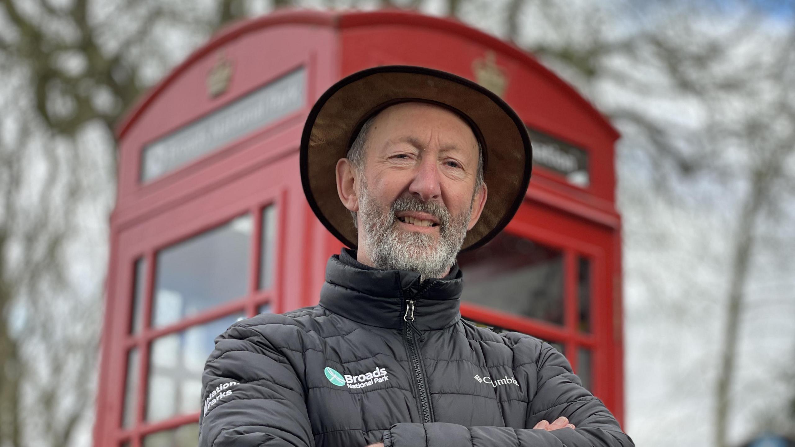 John Packman outside a red phonebox in Thurne