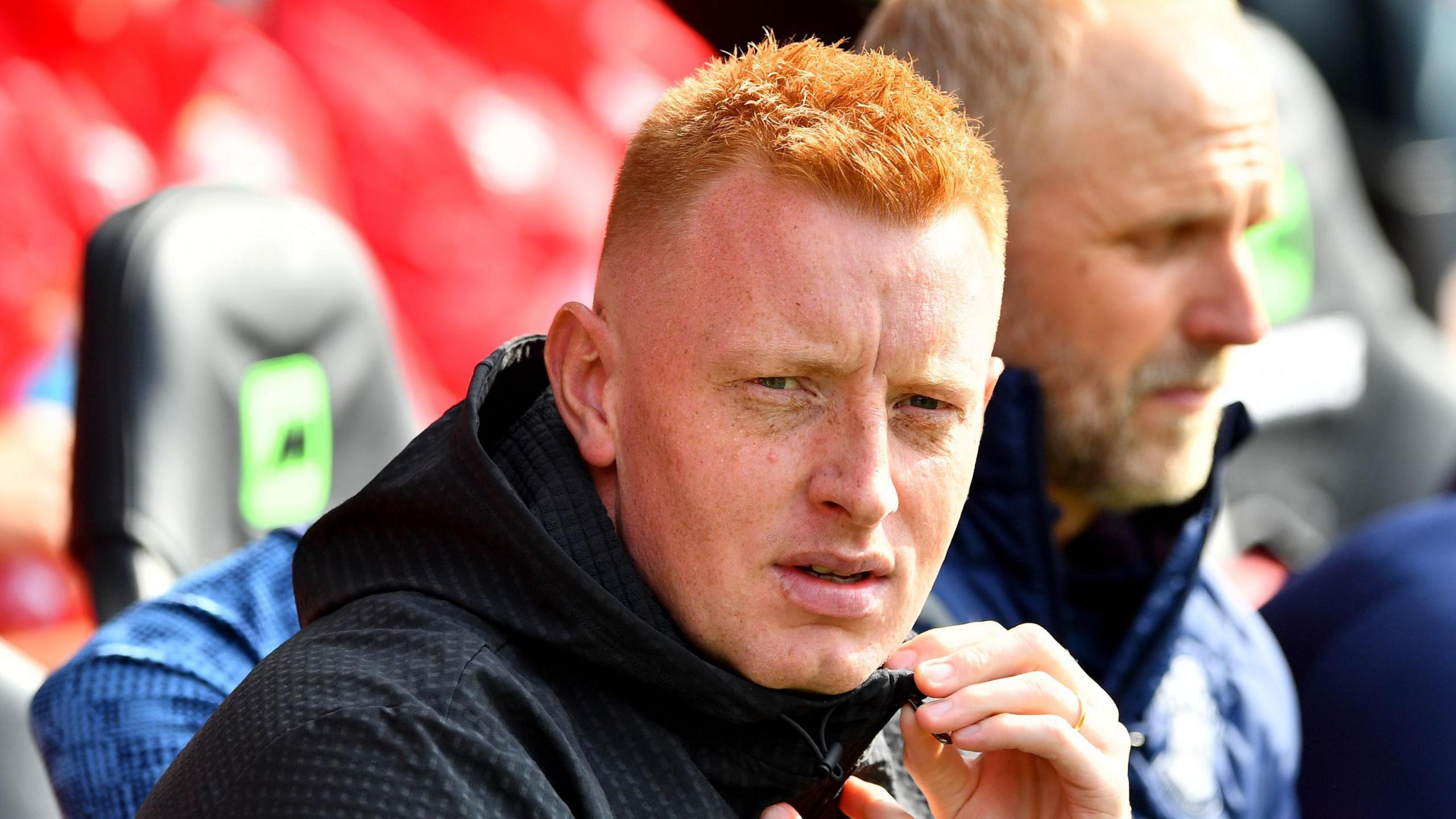 Will Still, wearing a hooded jacket, sat on the bench during the game with Middlesbrough 