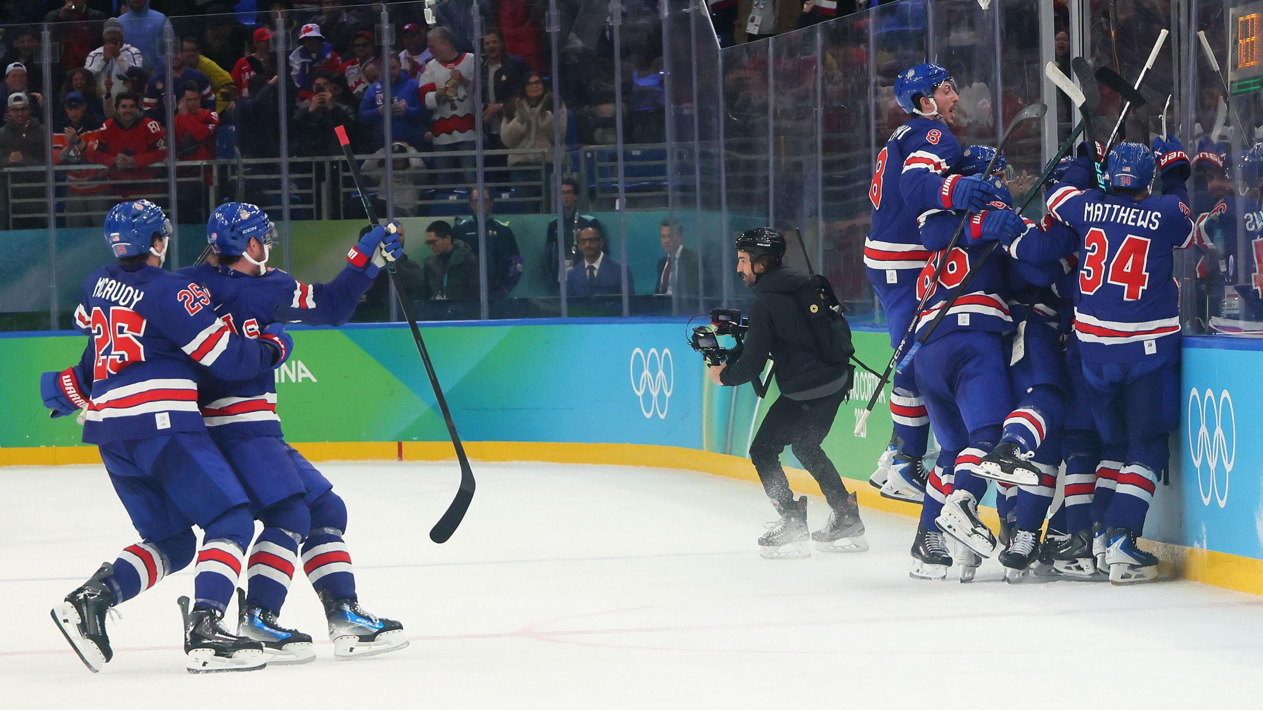 USA wildly celebrate Quinn Hughes' overtime winner against Sweden in the quarter-final